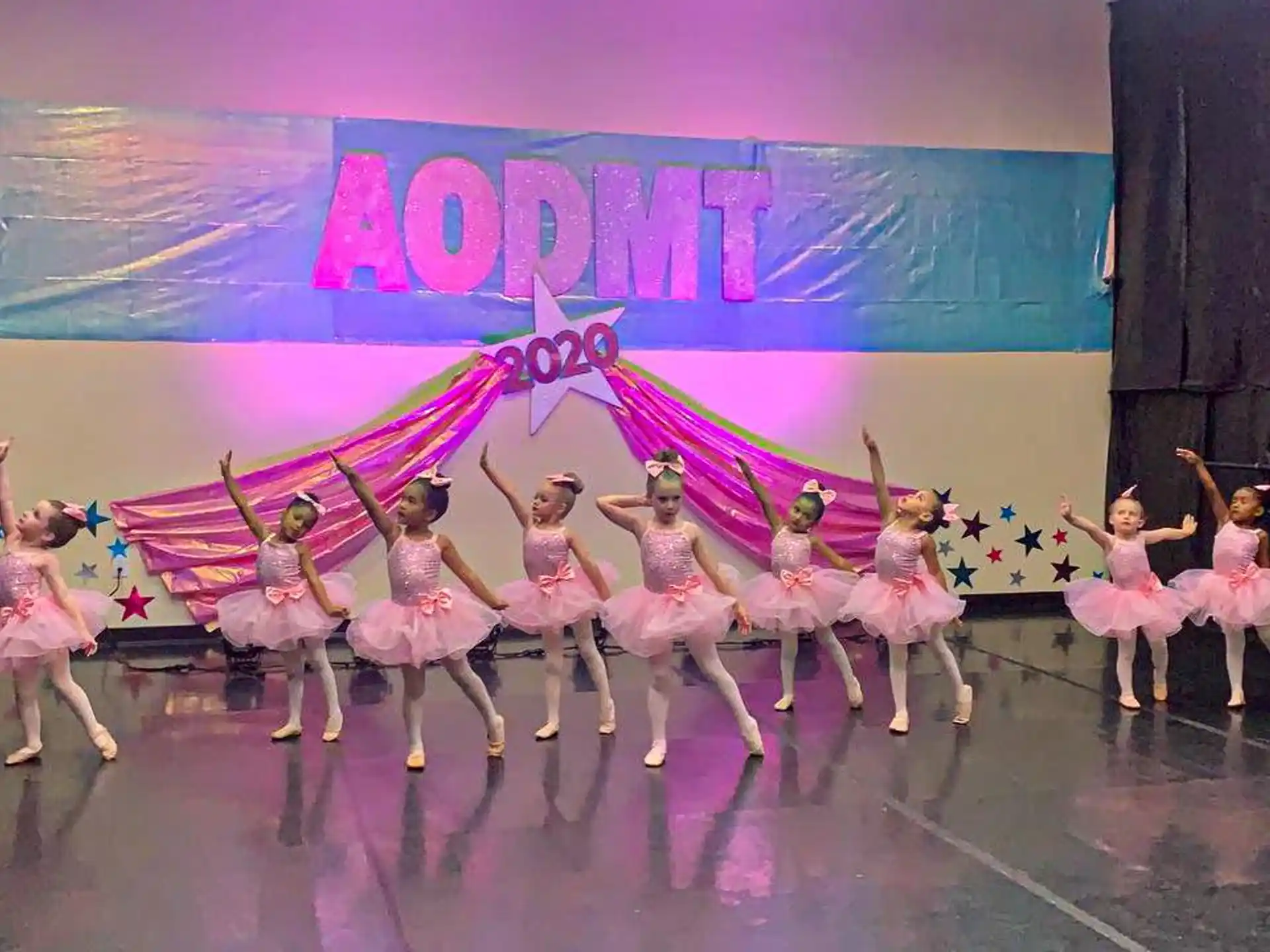 a group of dancers performing on a stage