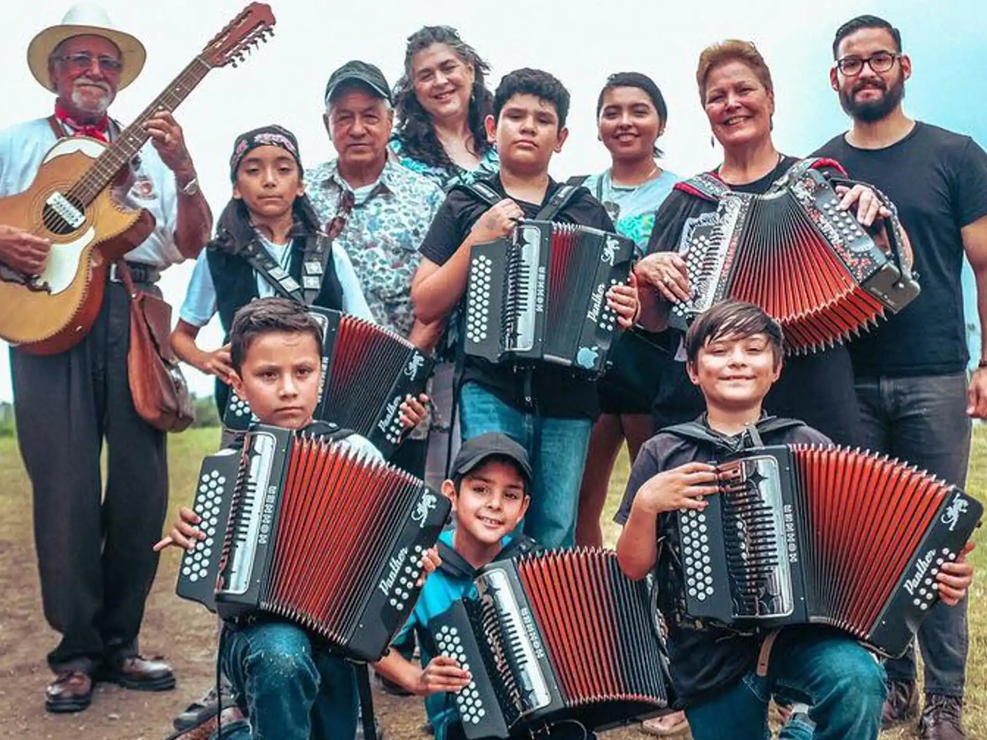 a group of people posing for a photo with musical instruments