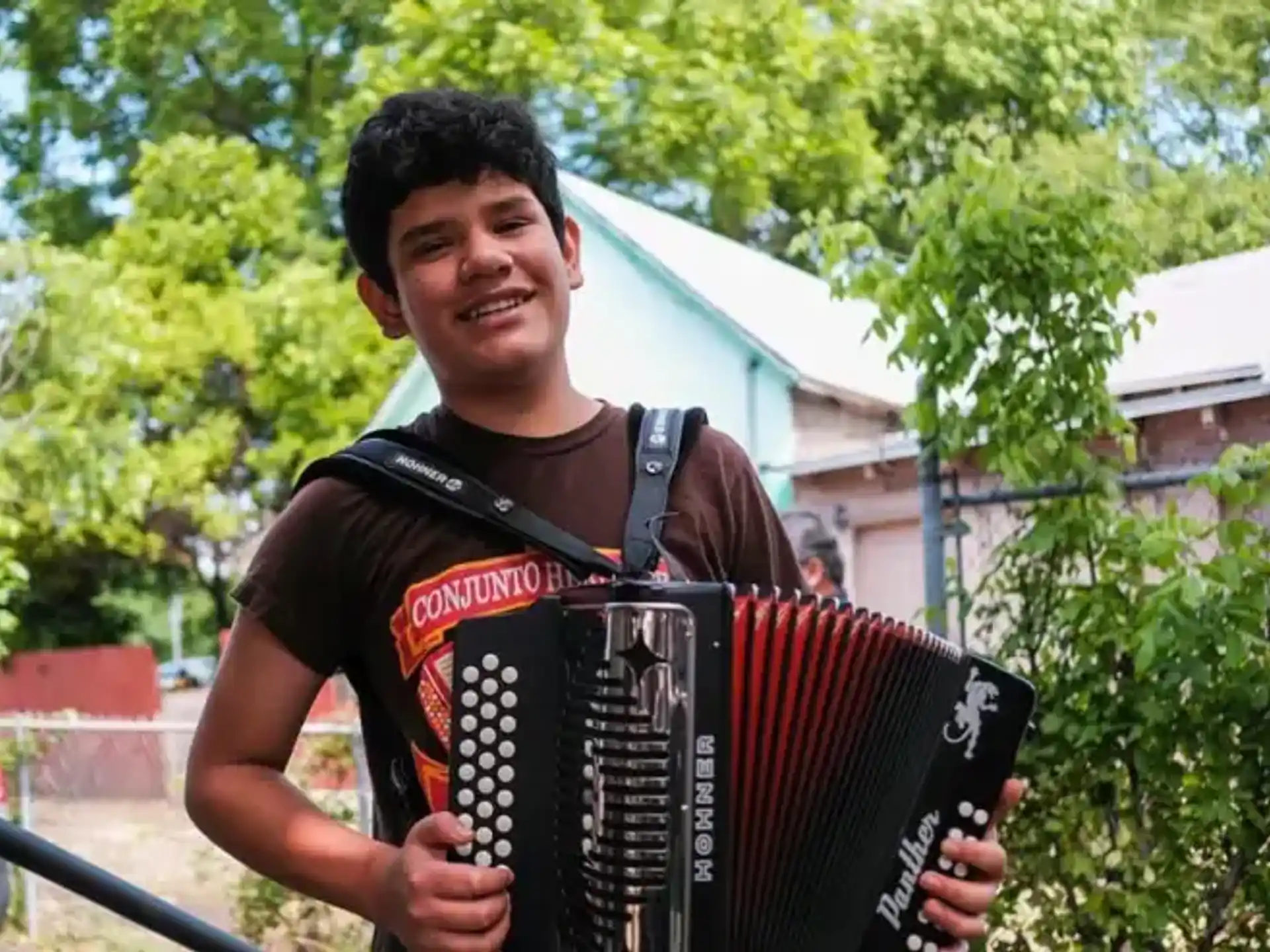 a man holding an accordion