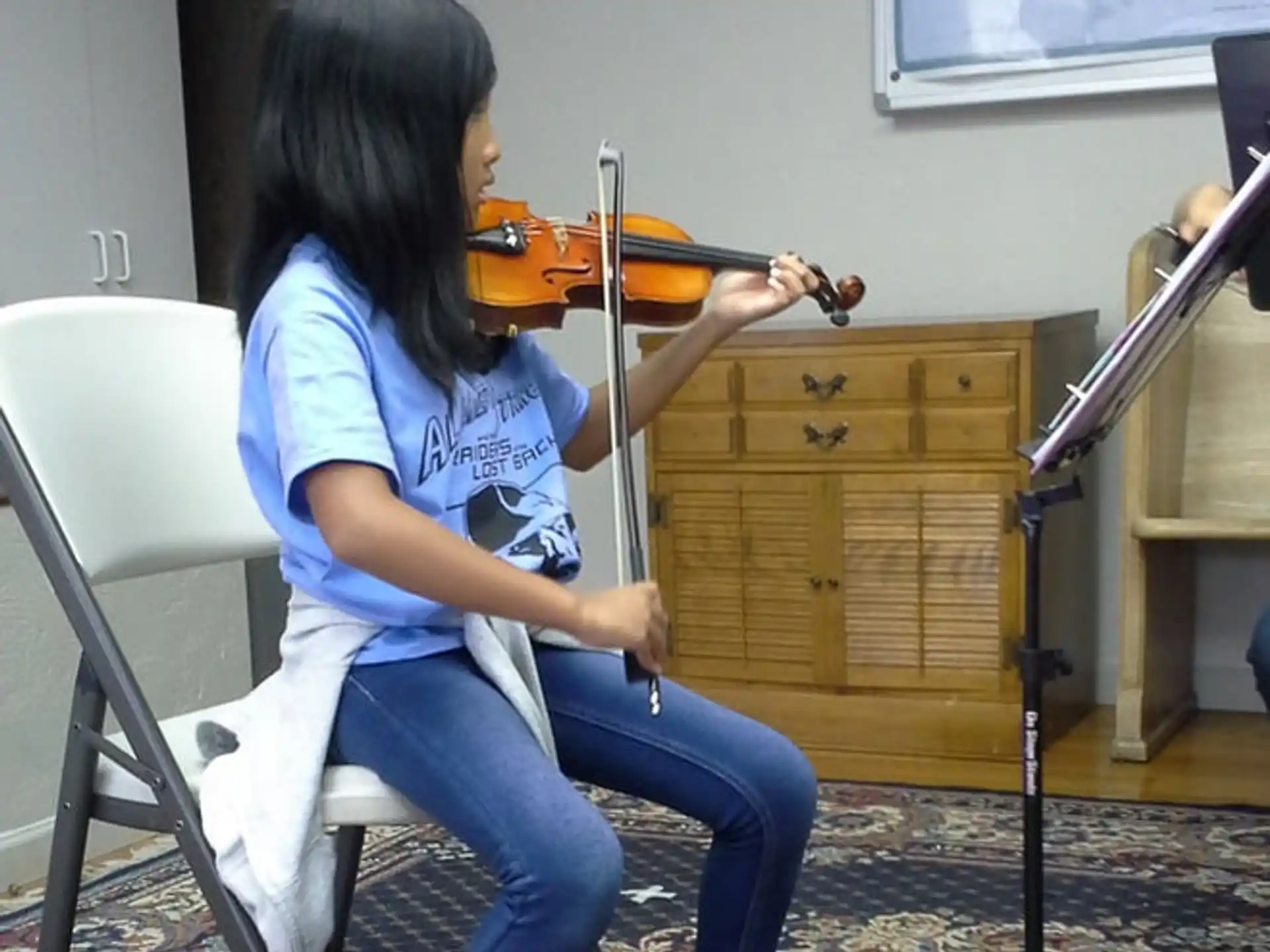 a woman playing a violin
