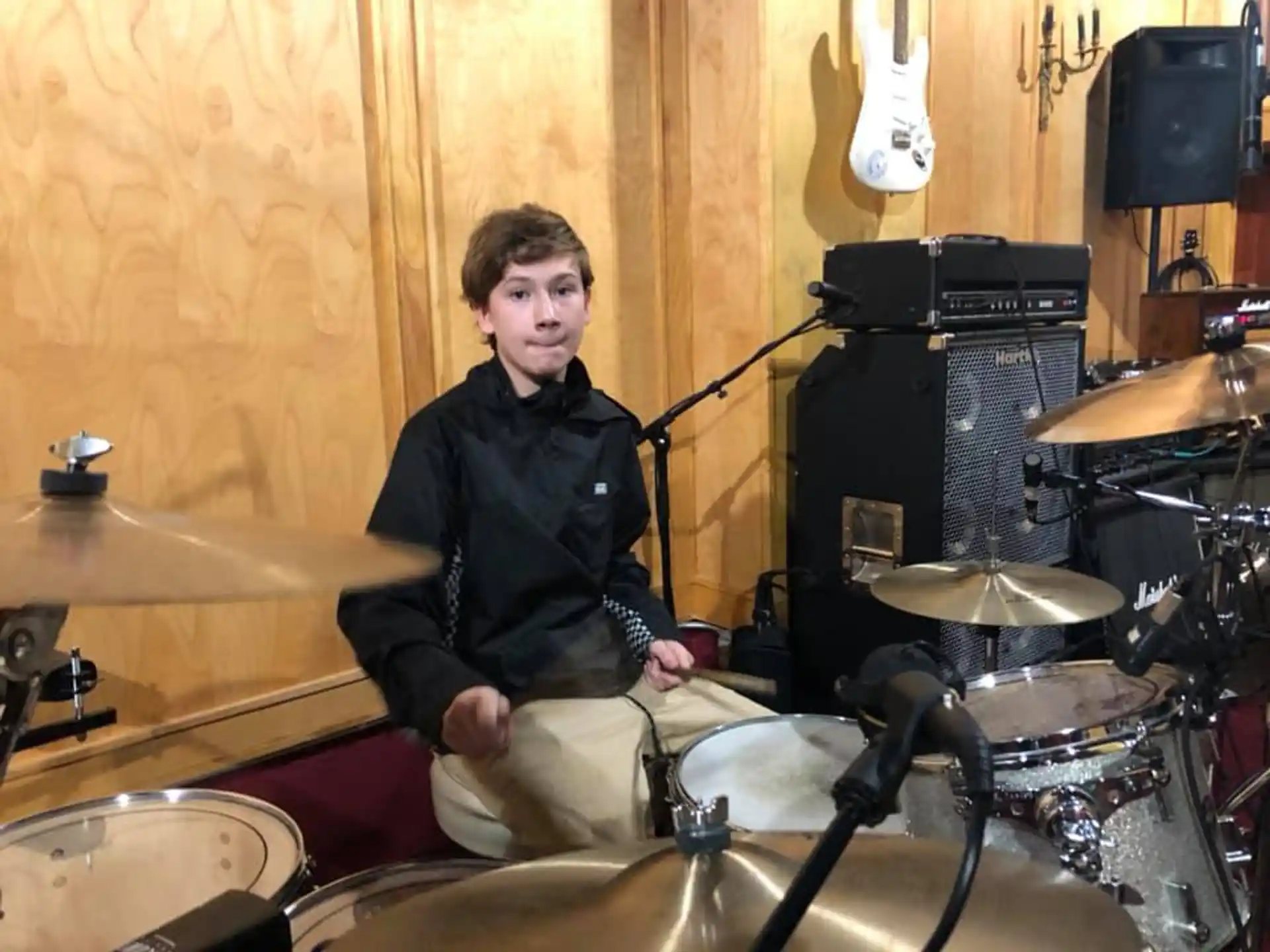 a person sitting on a drum set