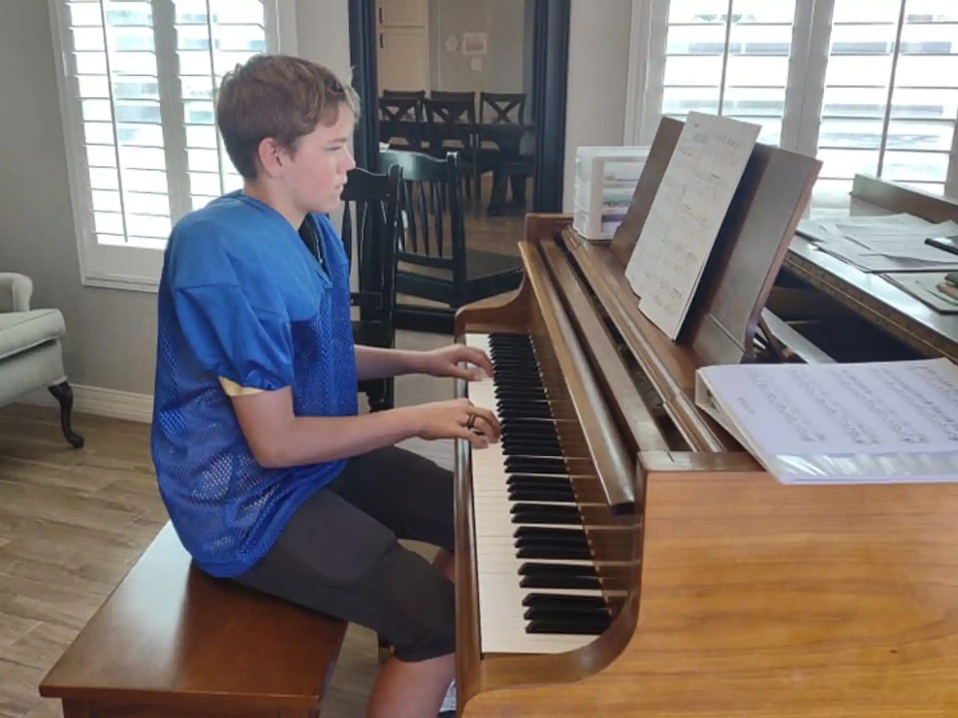 a boy playing a piano