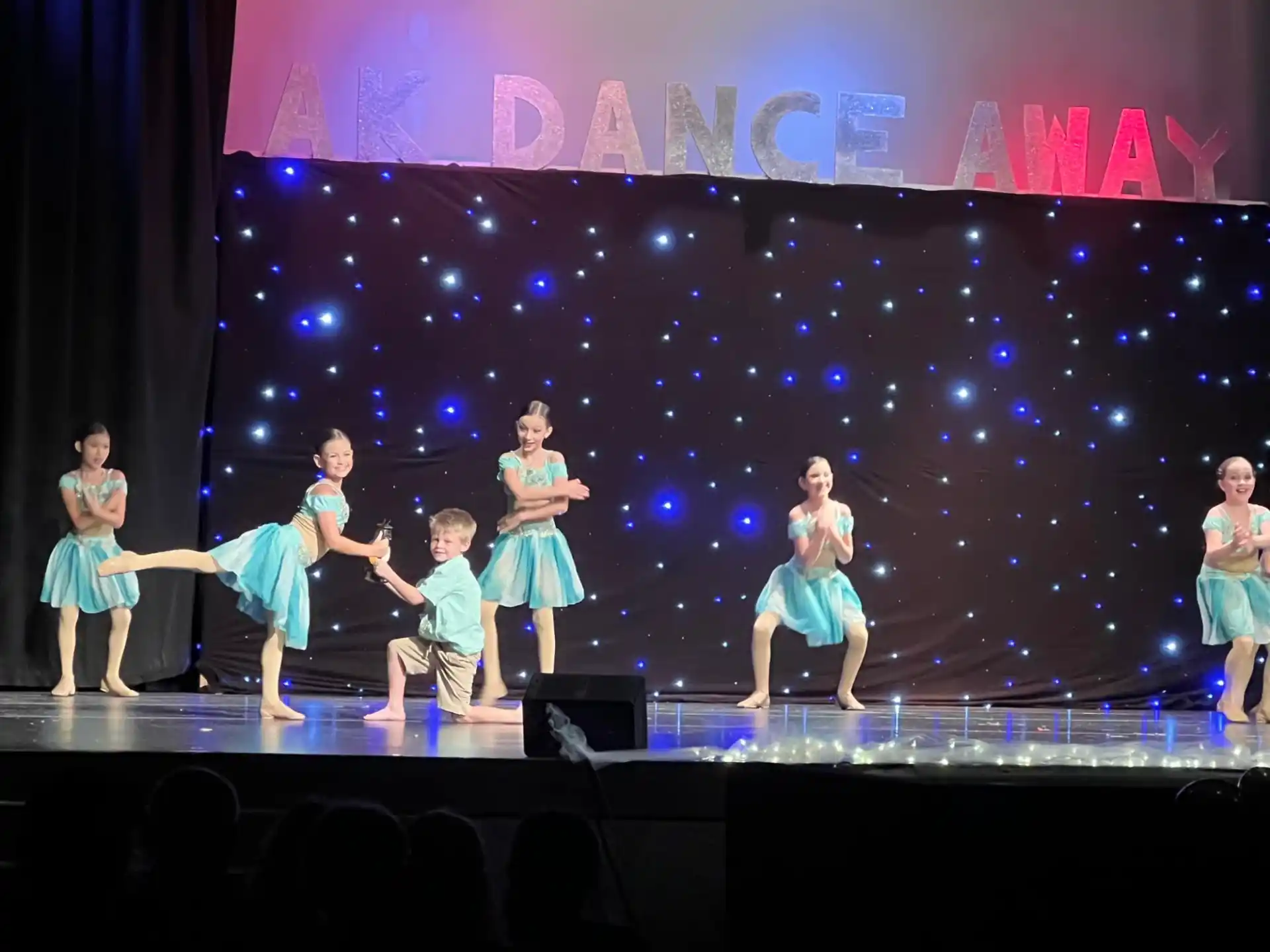 a group of children performing on a stage