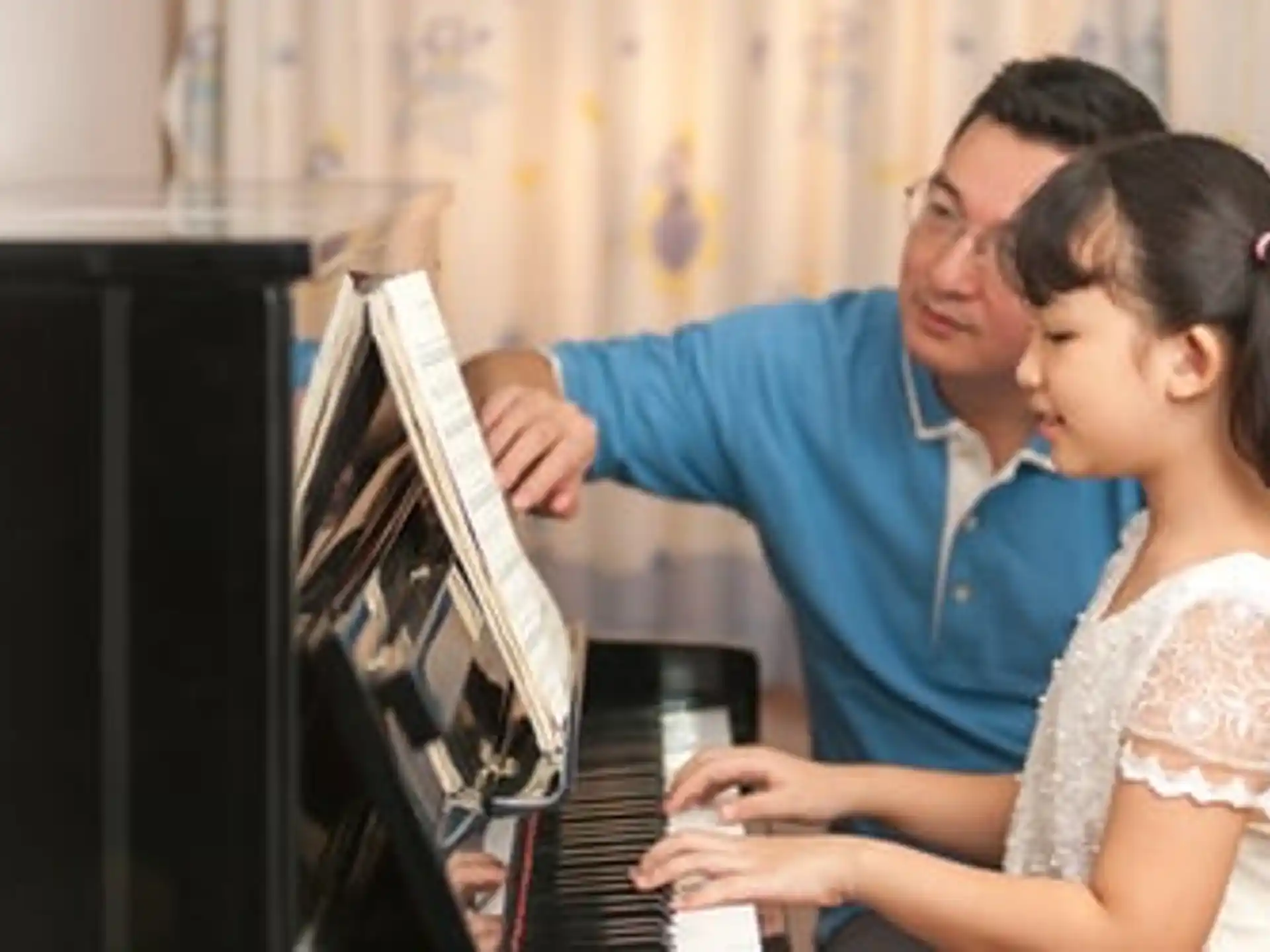 a person and a girl looking at a computer