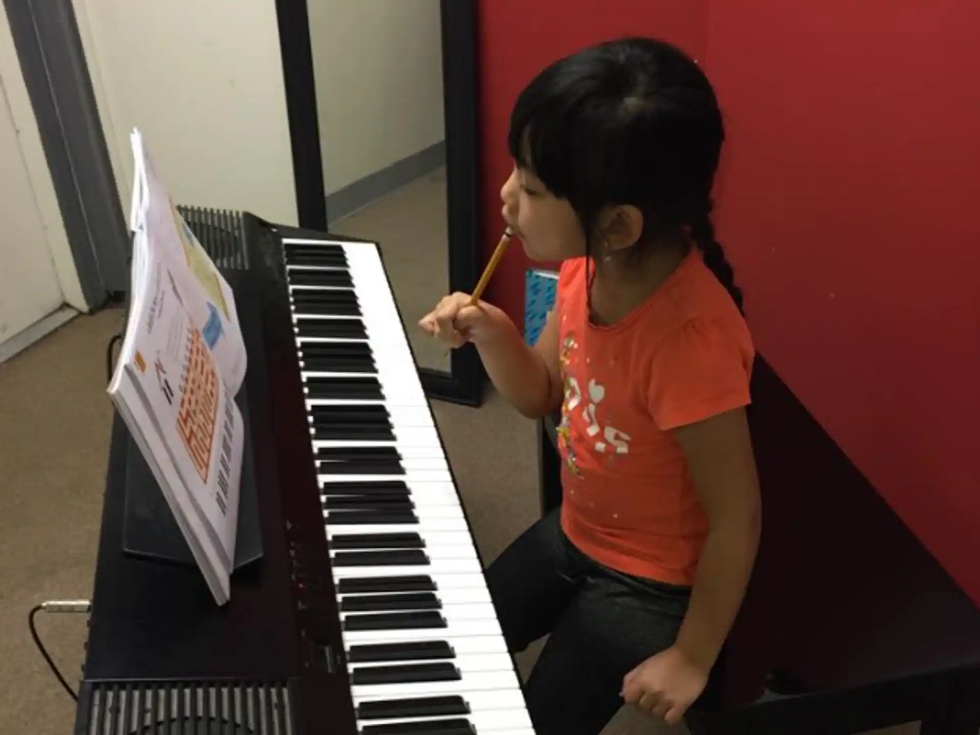a girl playing a piano