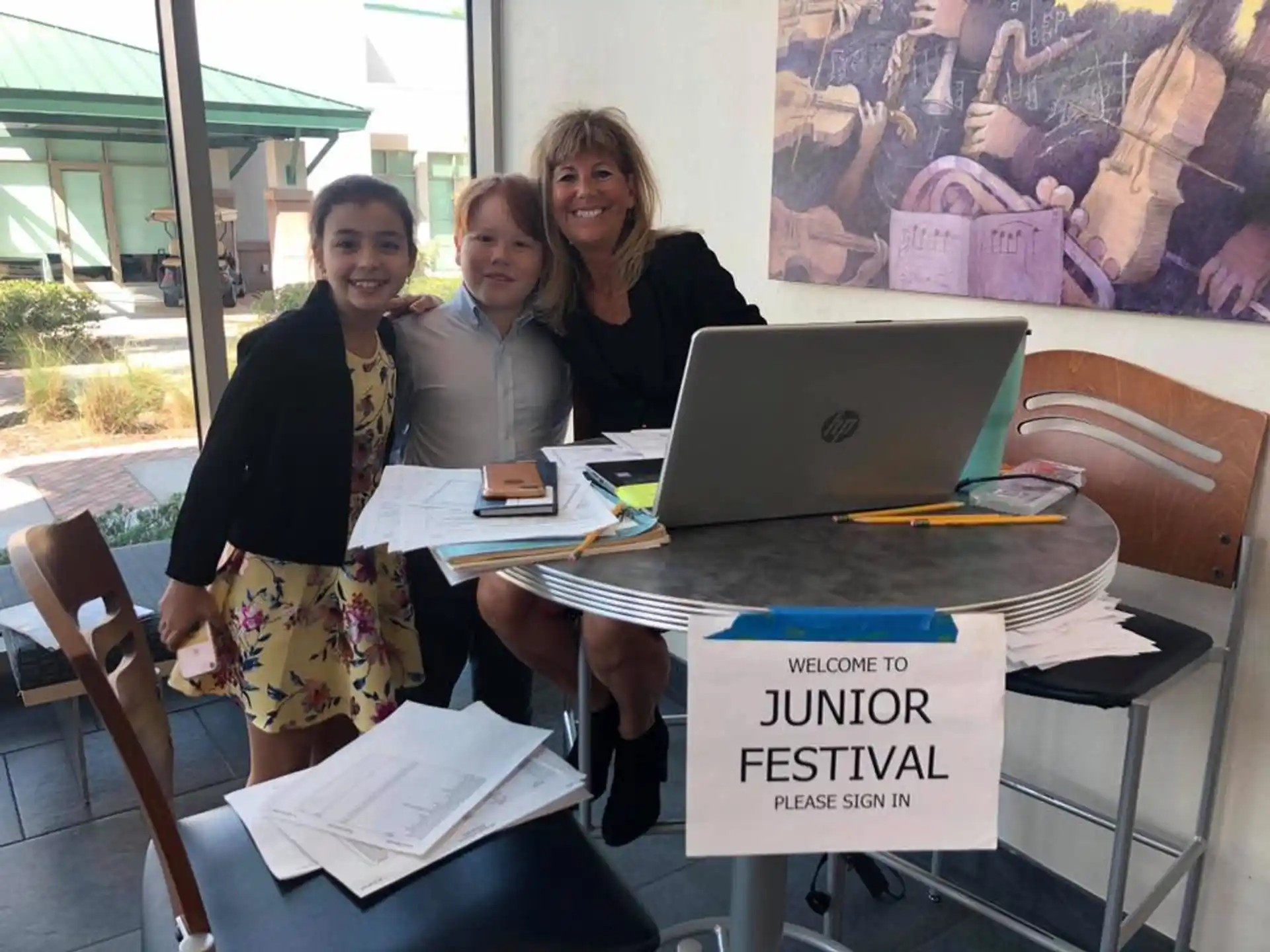 a group of women sitting at a table with a laptop