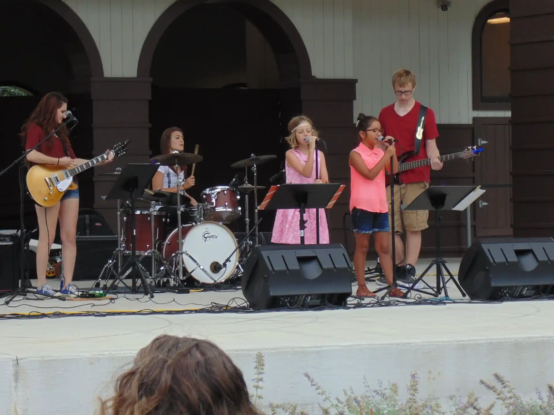 a group of people playing instruments on a stage