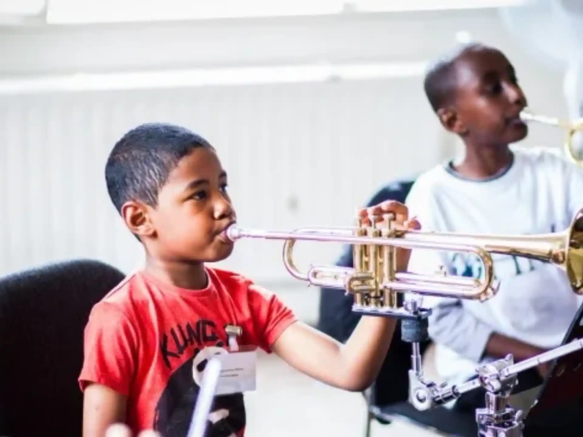 a boy playing a trumpet