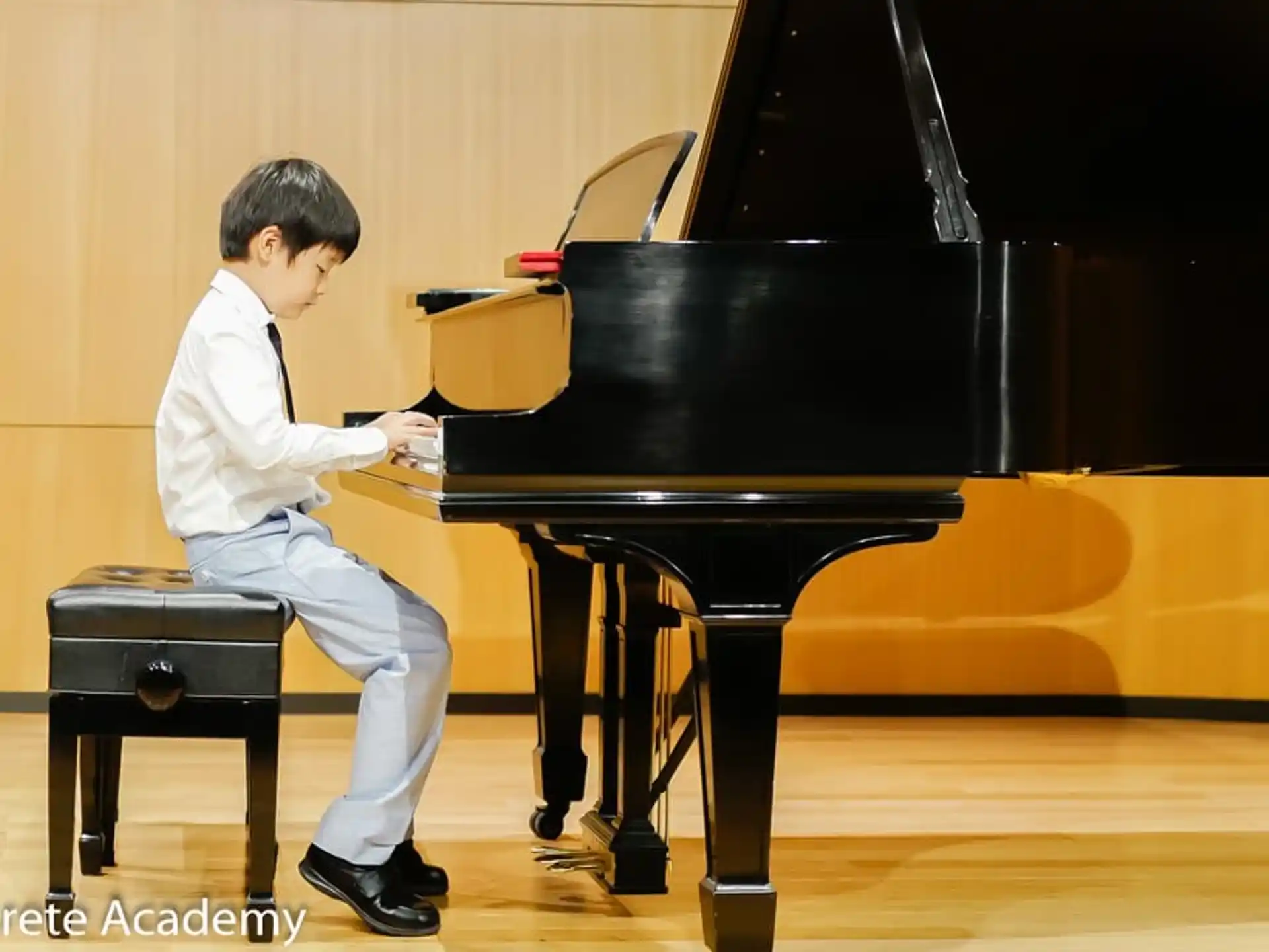 a boy playing a piano