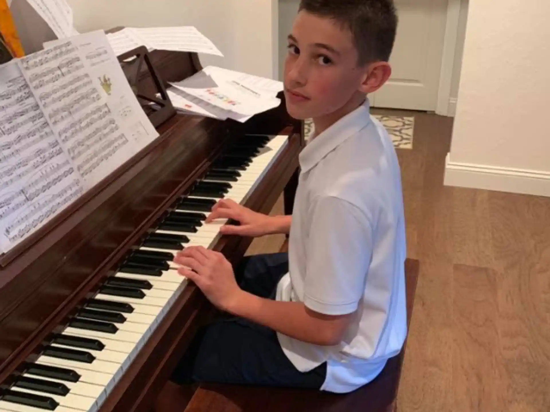a boy playing a piano
