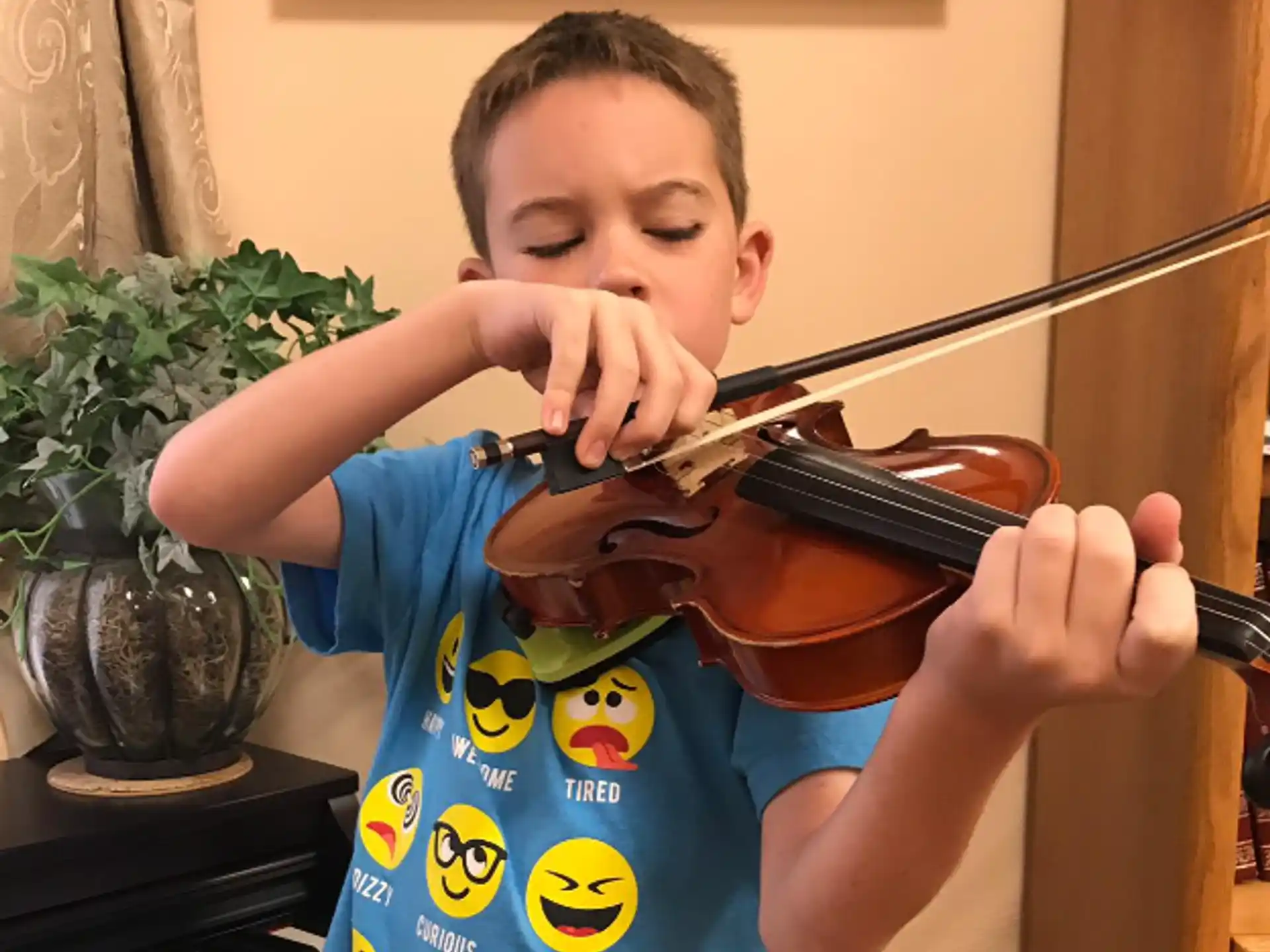 a boy playing a violin