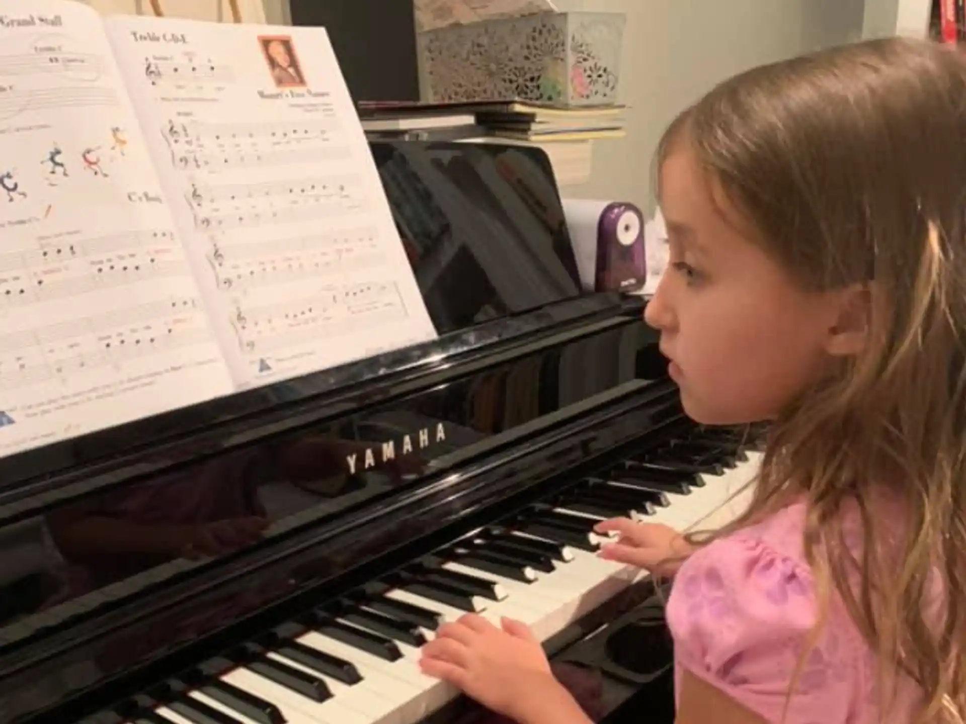 a girl playing a piano