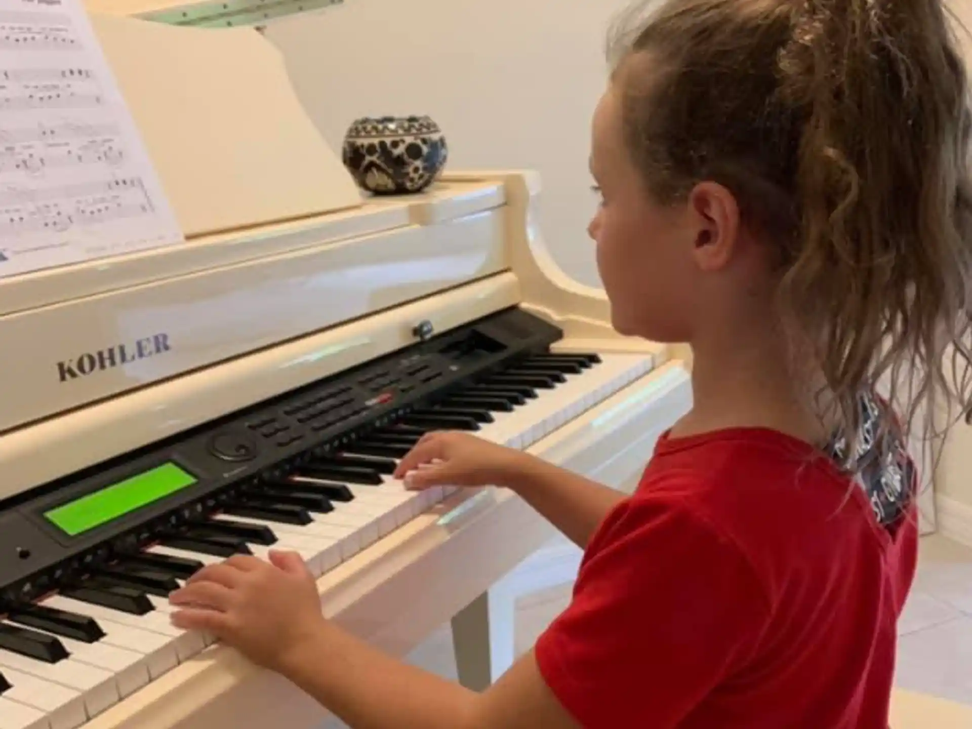 a young girl playing a piano