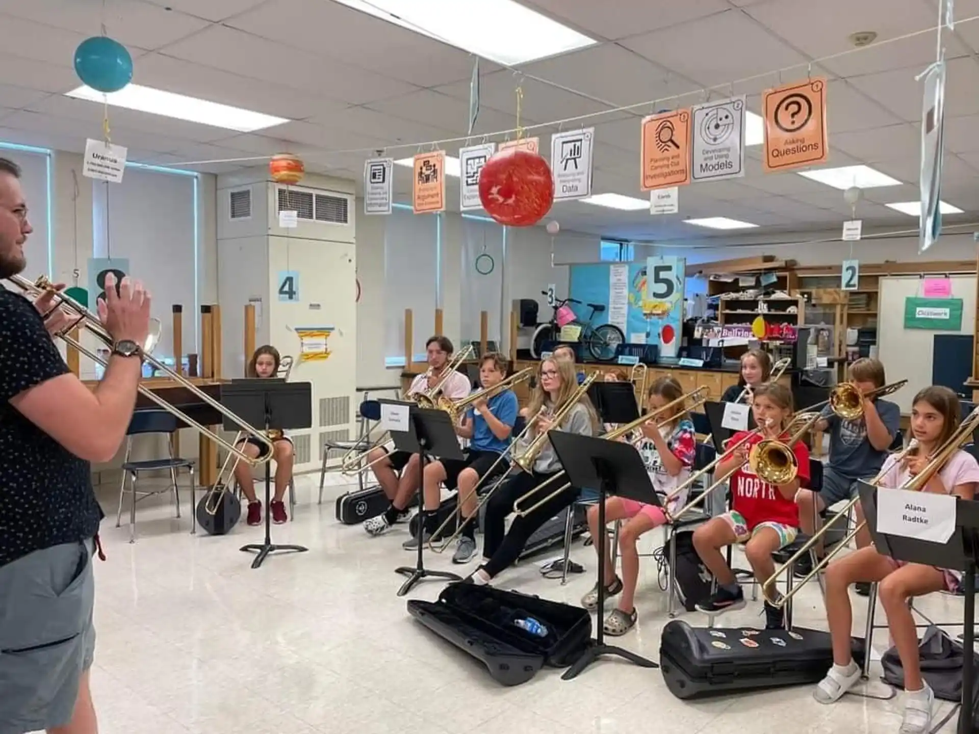 a group of people sitting in a room with instruments