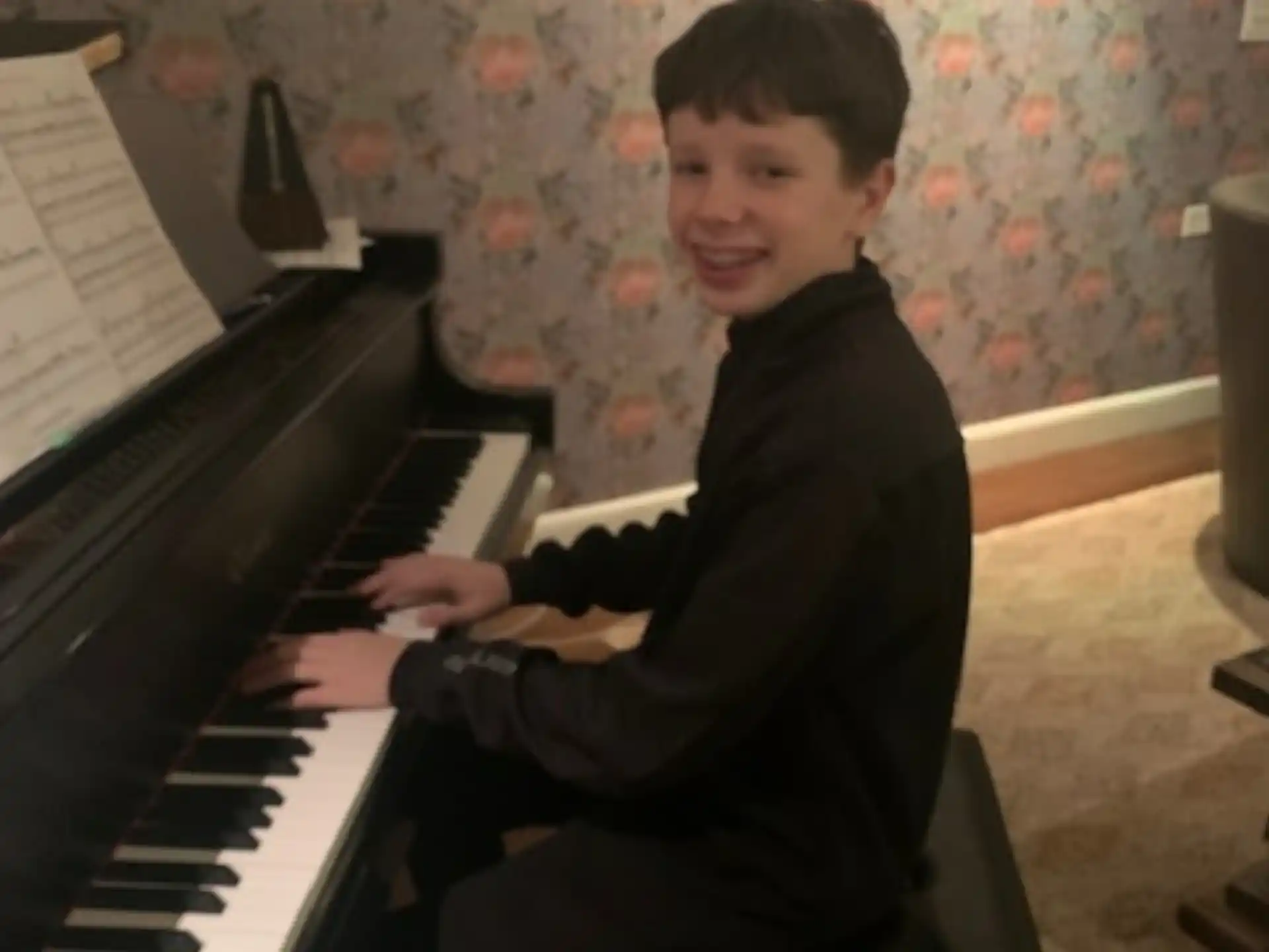 a boy playing a piano