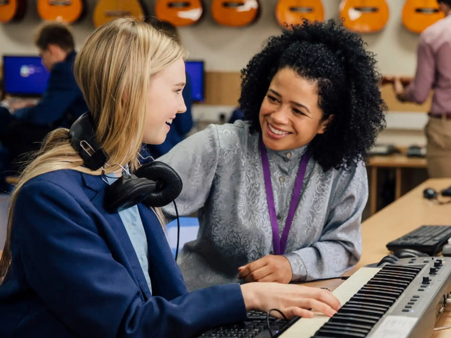 a couple of women playing a piano