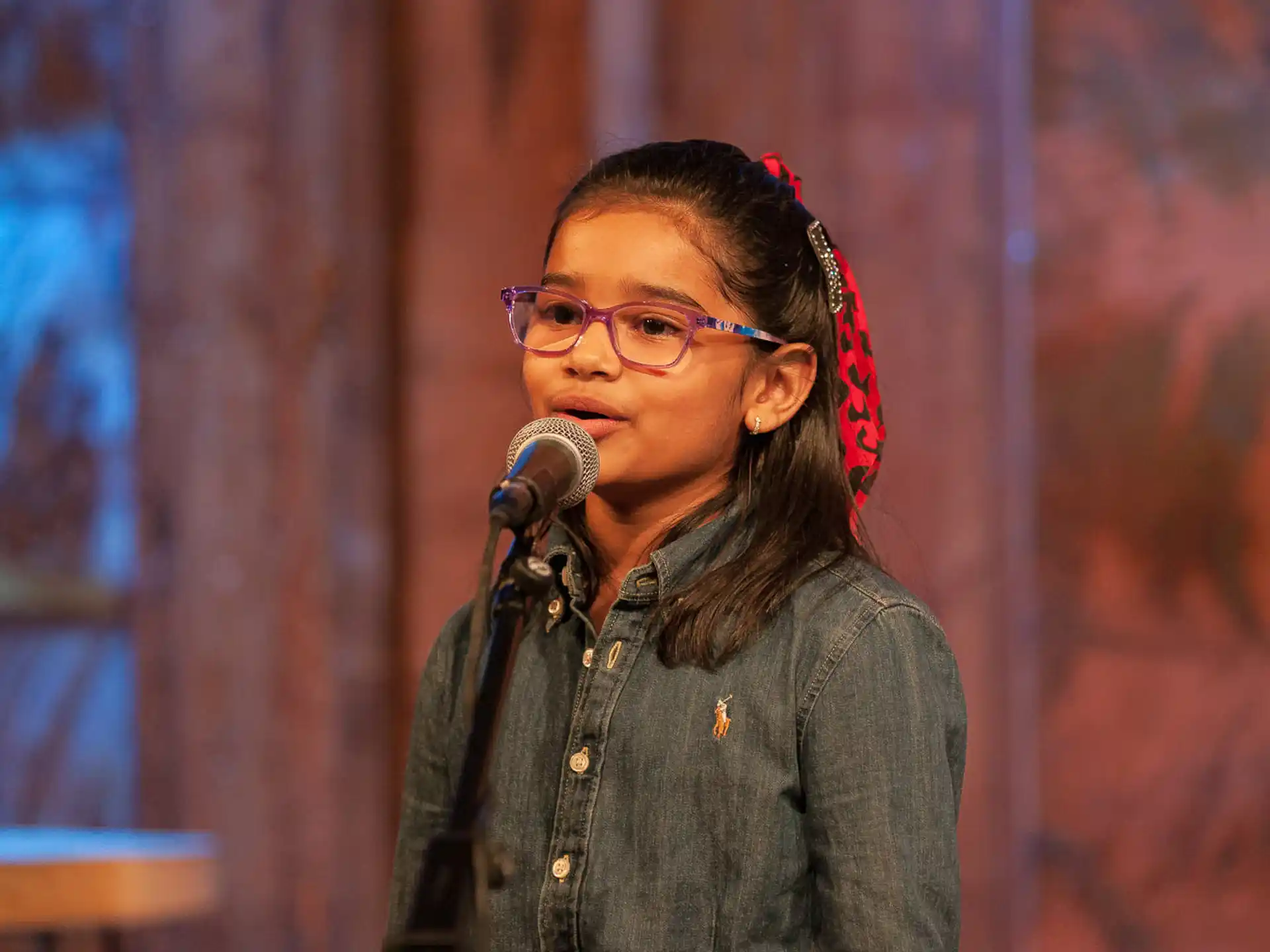 a person with glasses and a microphone