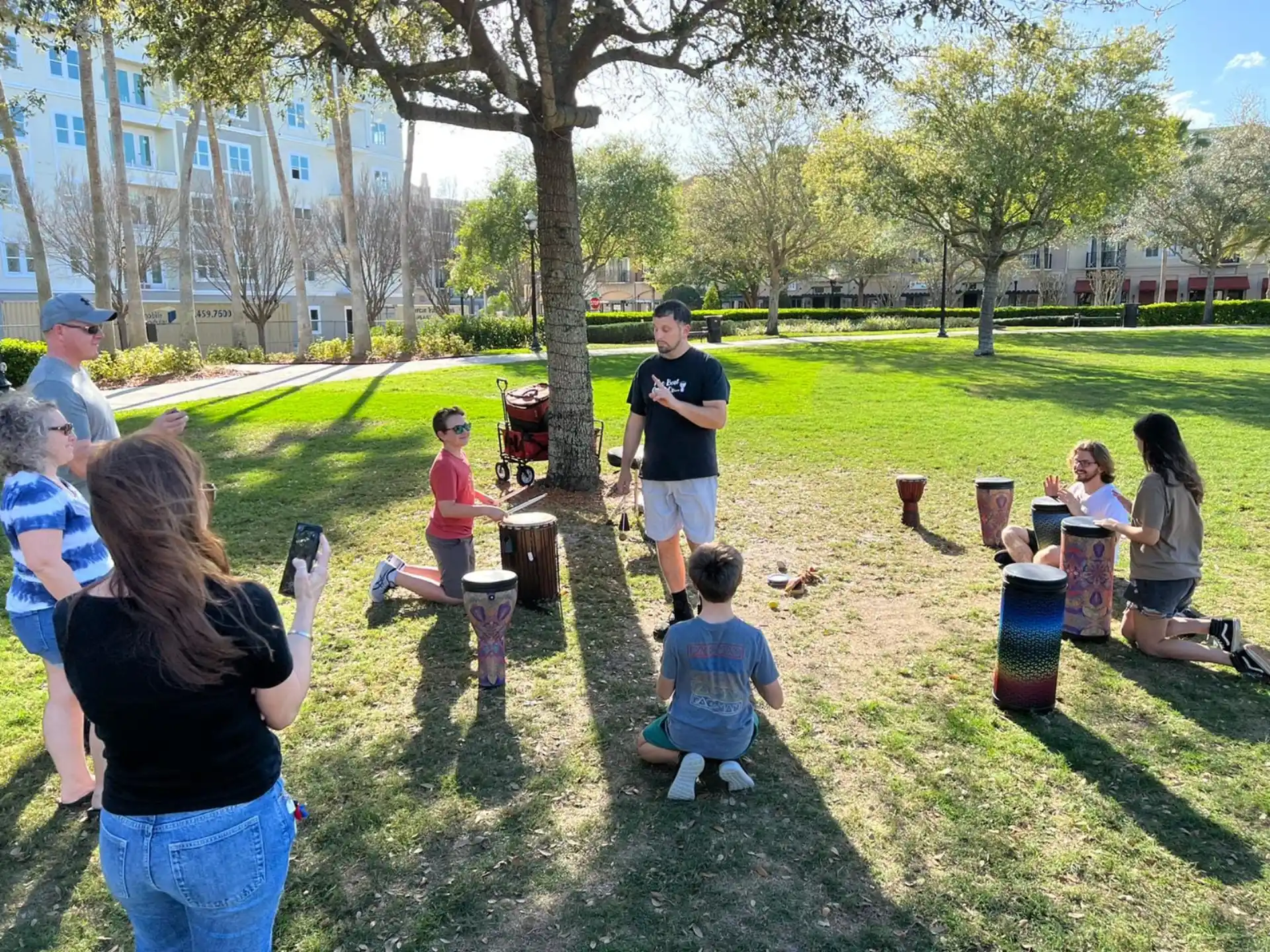 a group of people sitting on the grass