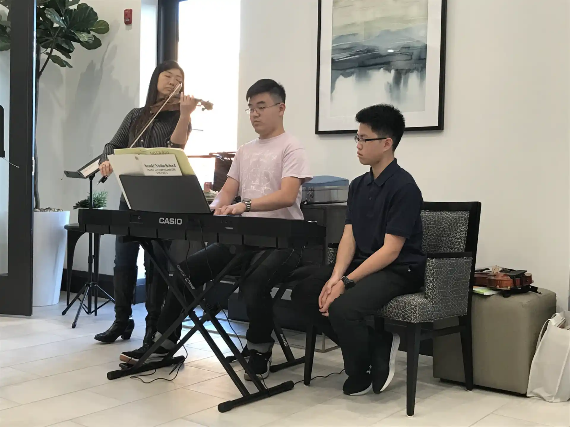 a group of people sitting around a piano