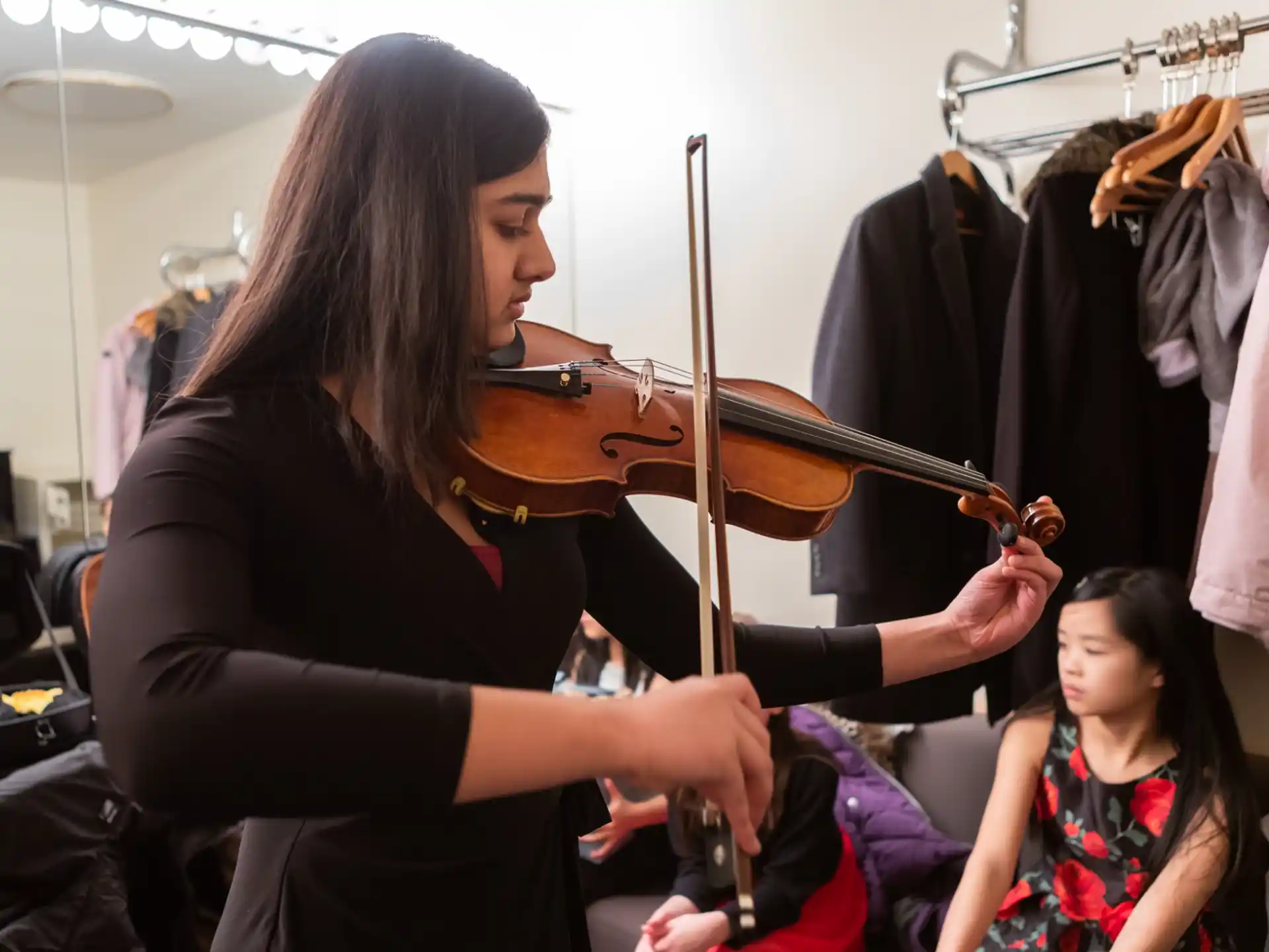a woman playing a violin