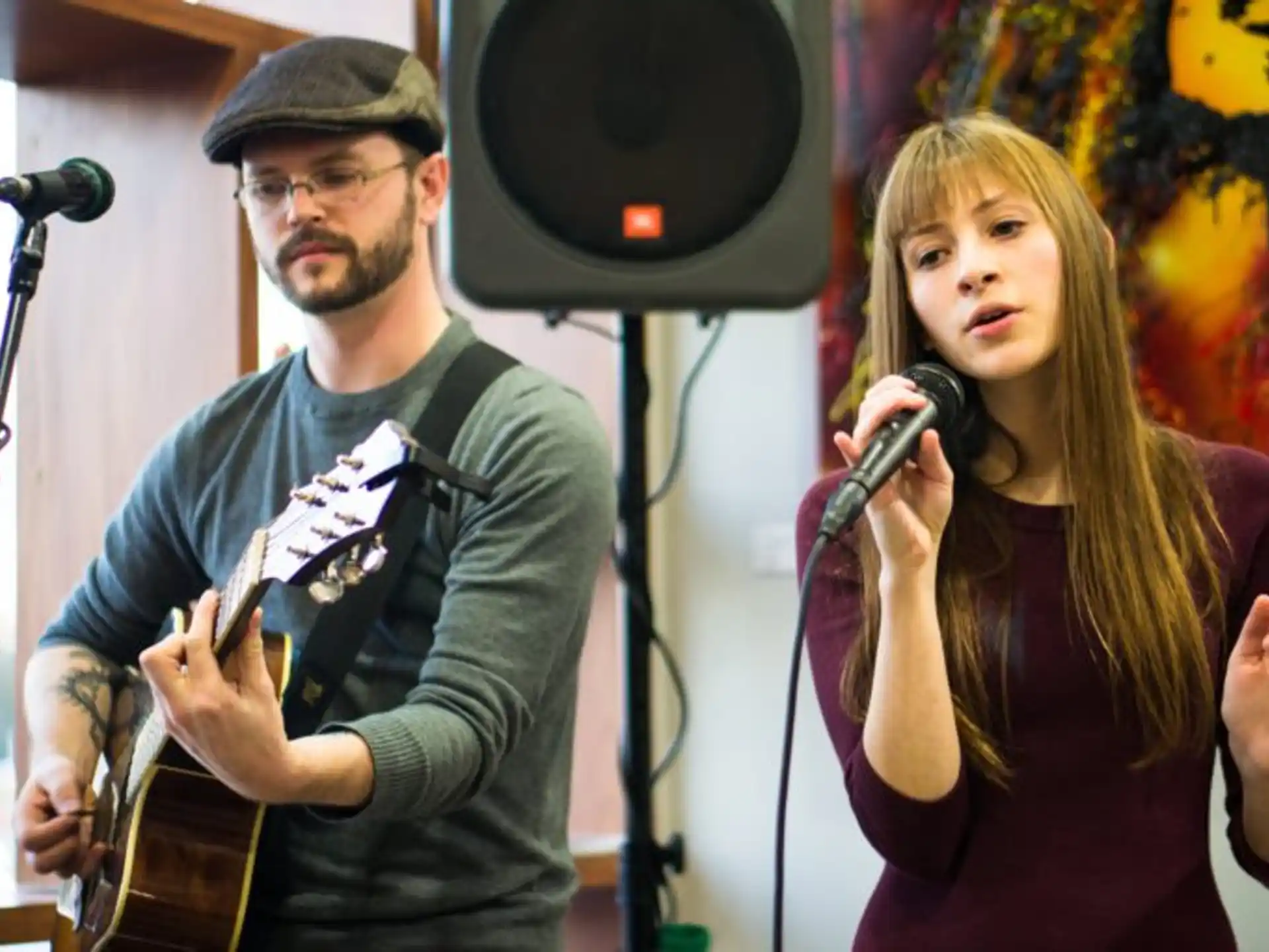a man and woman singing into microphones