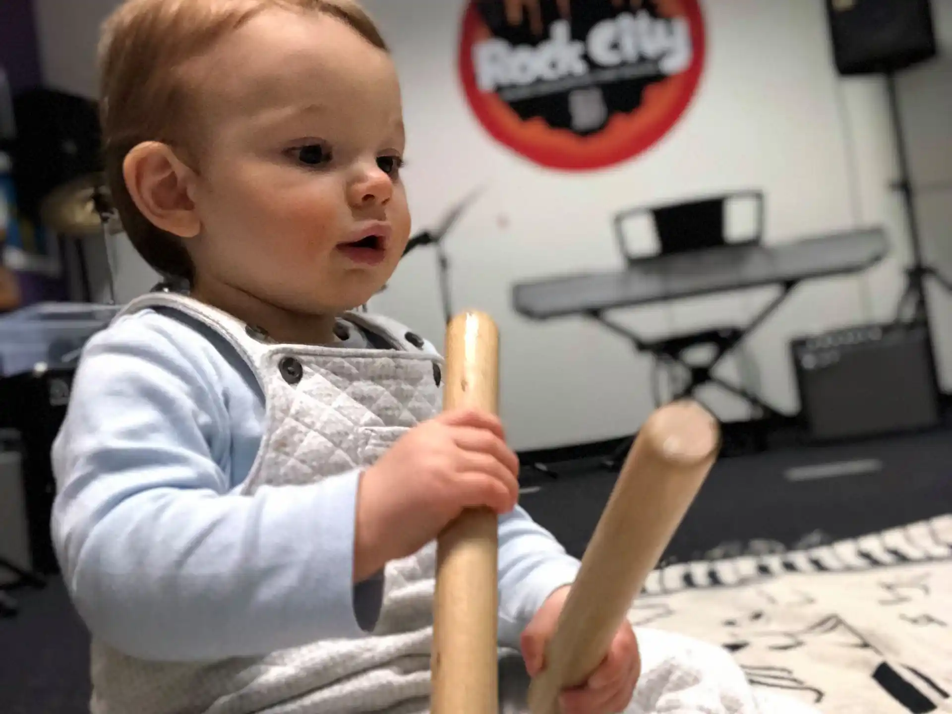 a baby holding a baseball bat