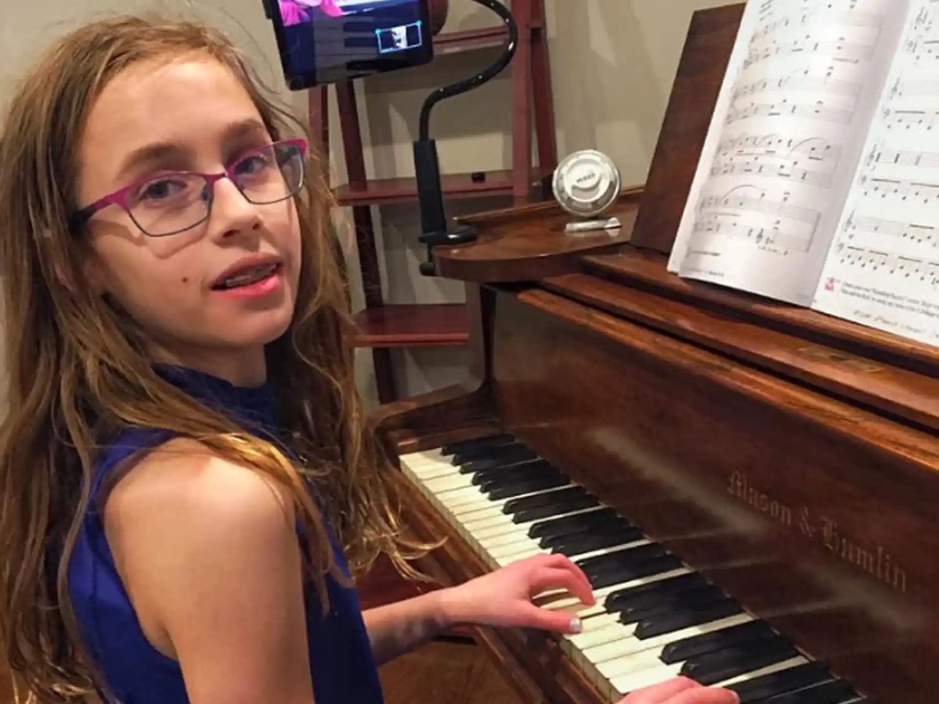 a girl playing a piano