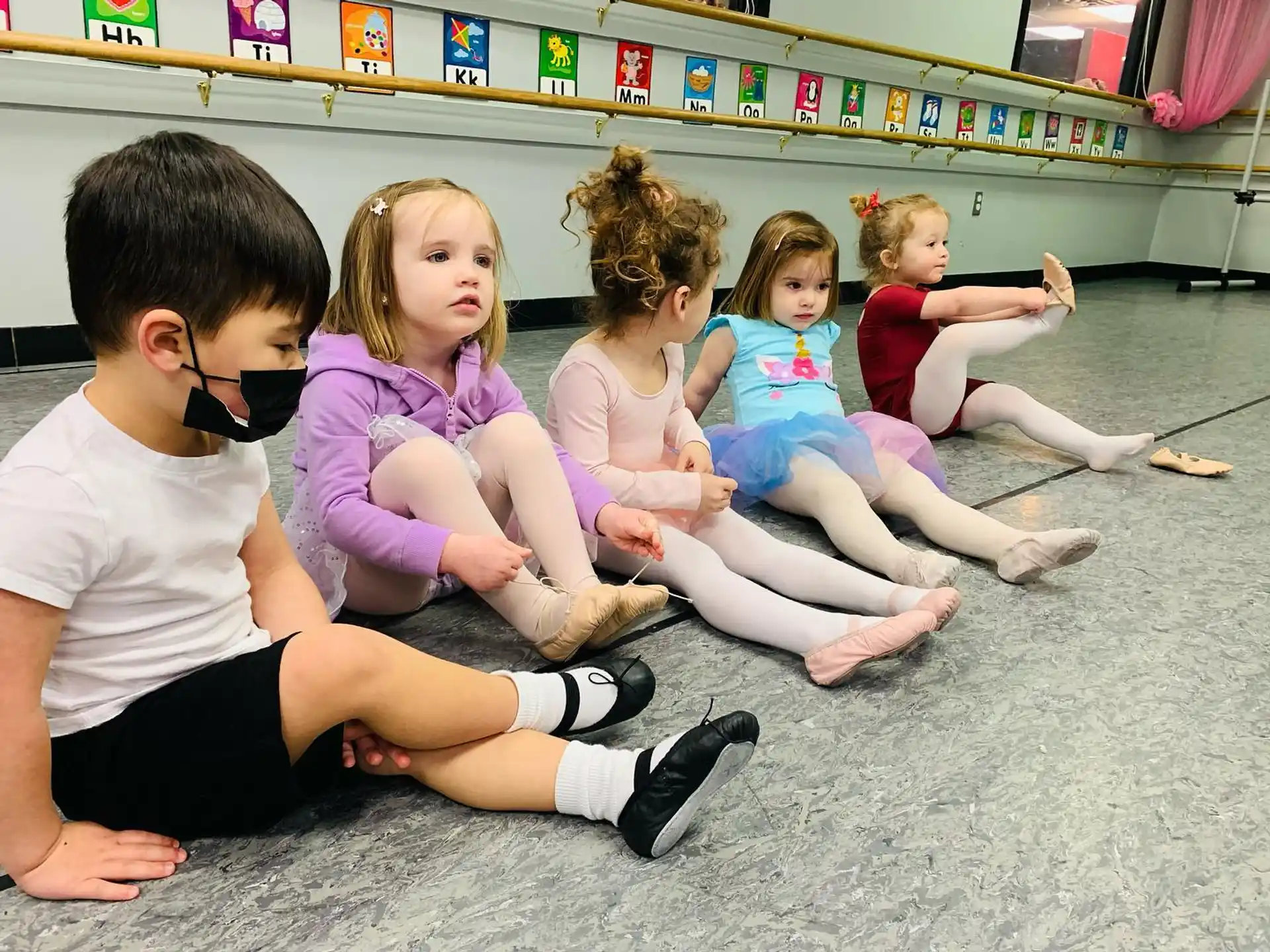 a group of children sitting on the floor