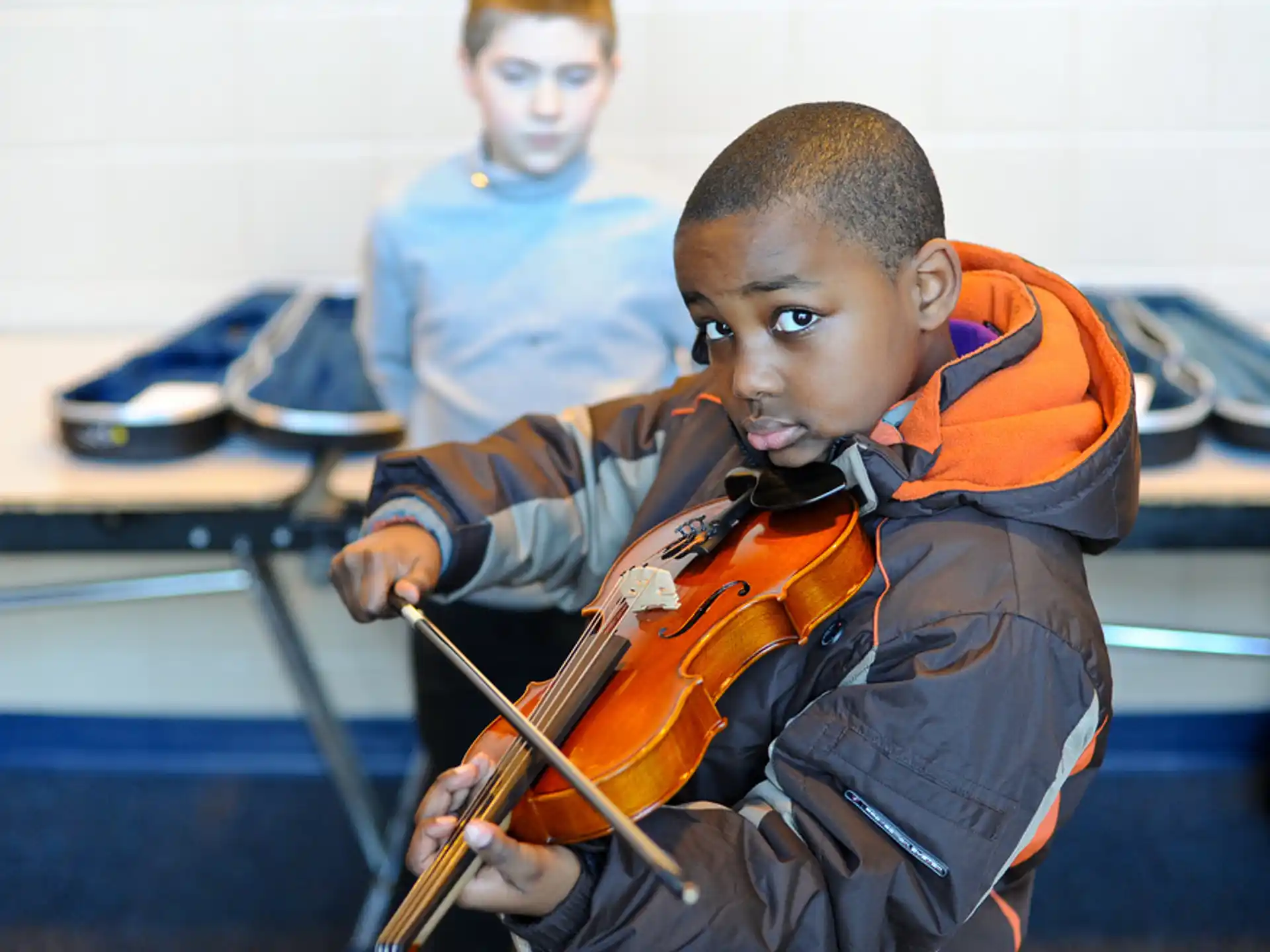 a young boy playing a violin