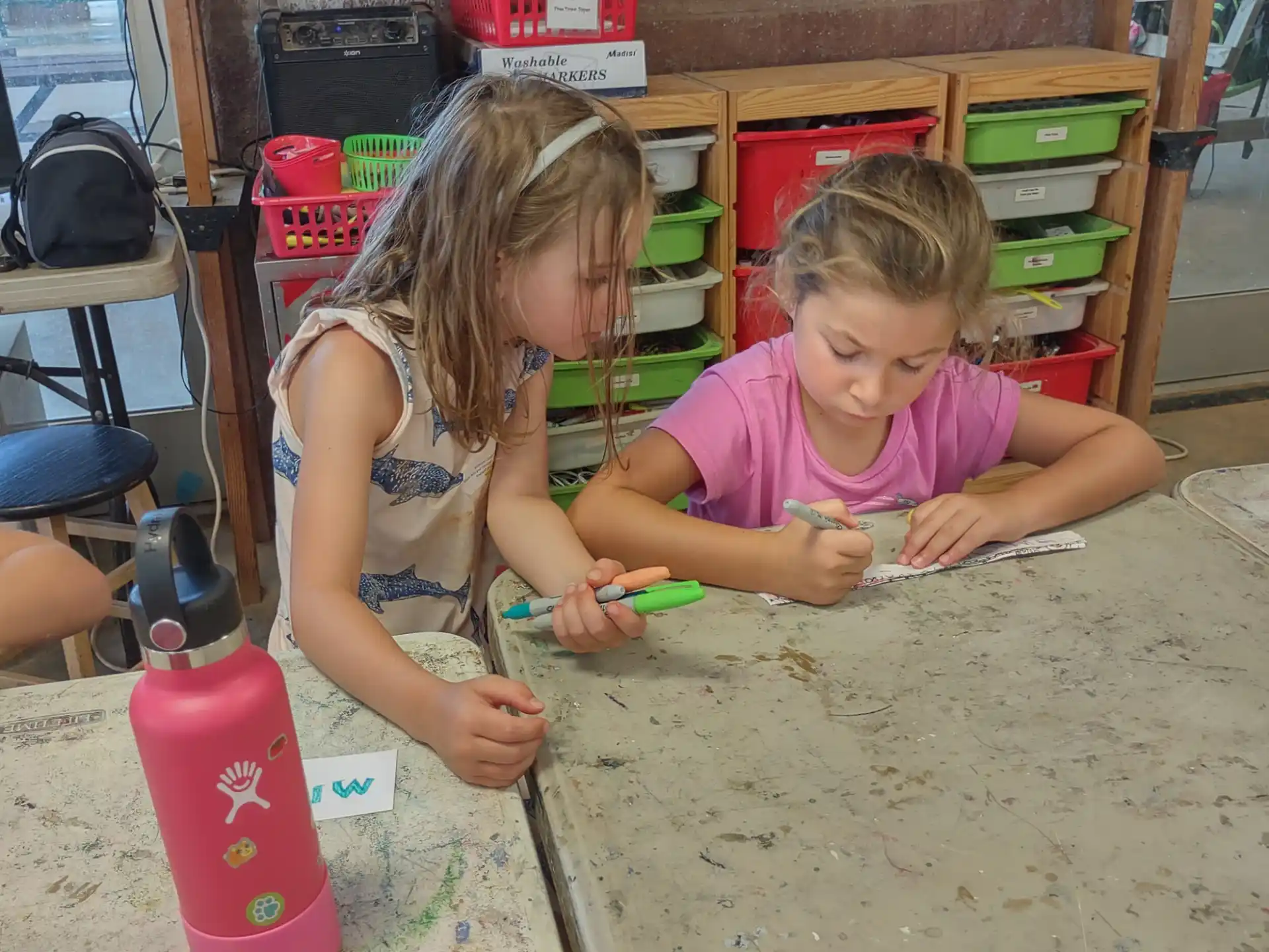 a couple of young girls playing with toys in a room