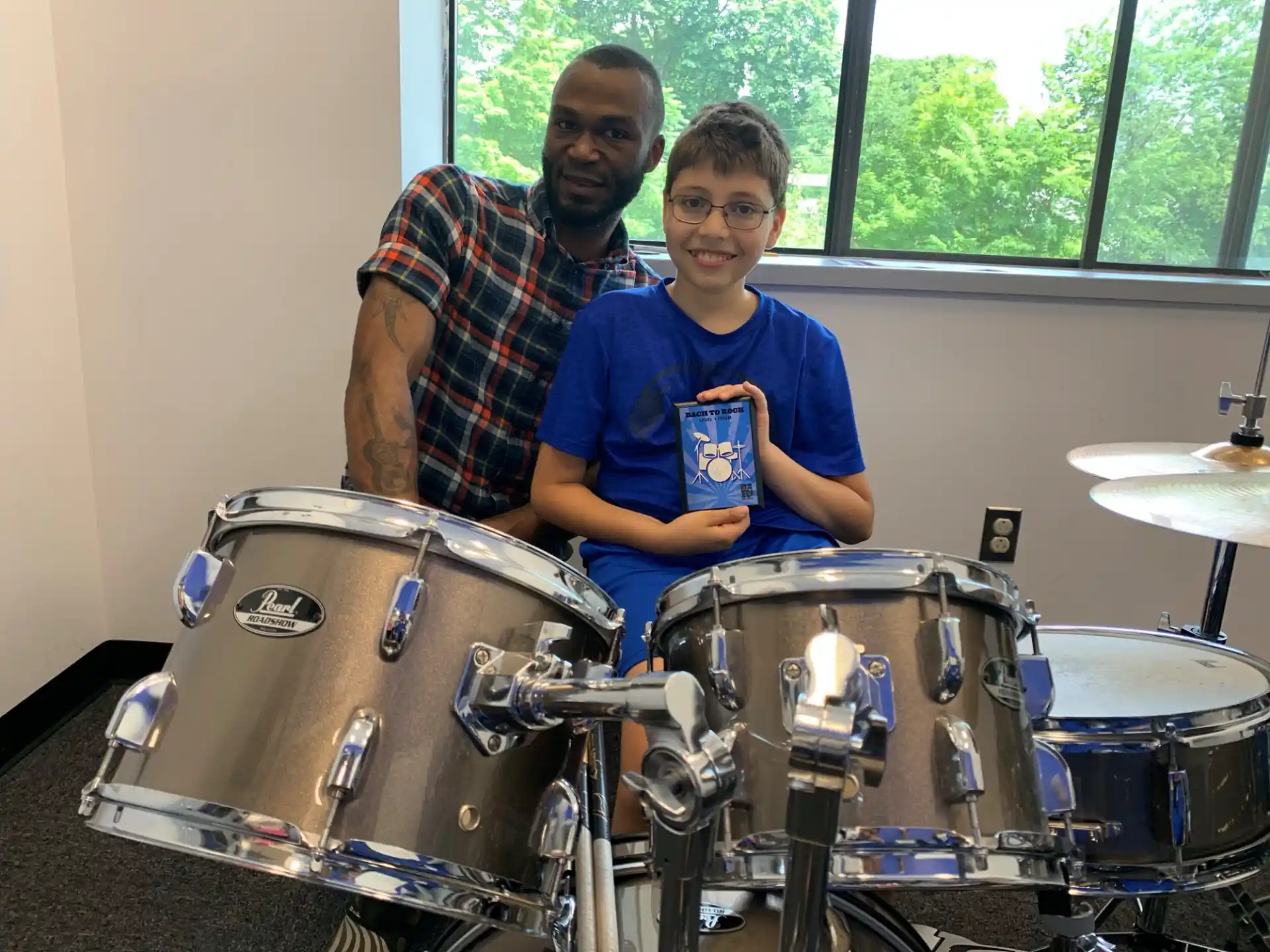 a man and a boy with drums