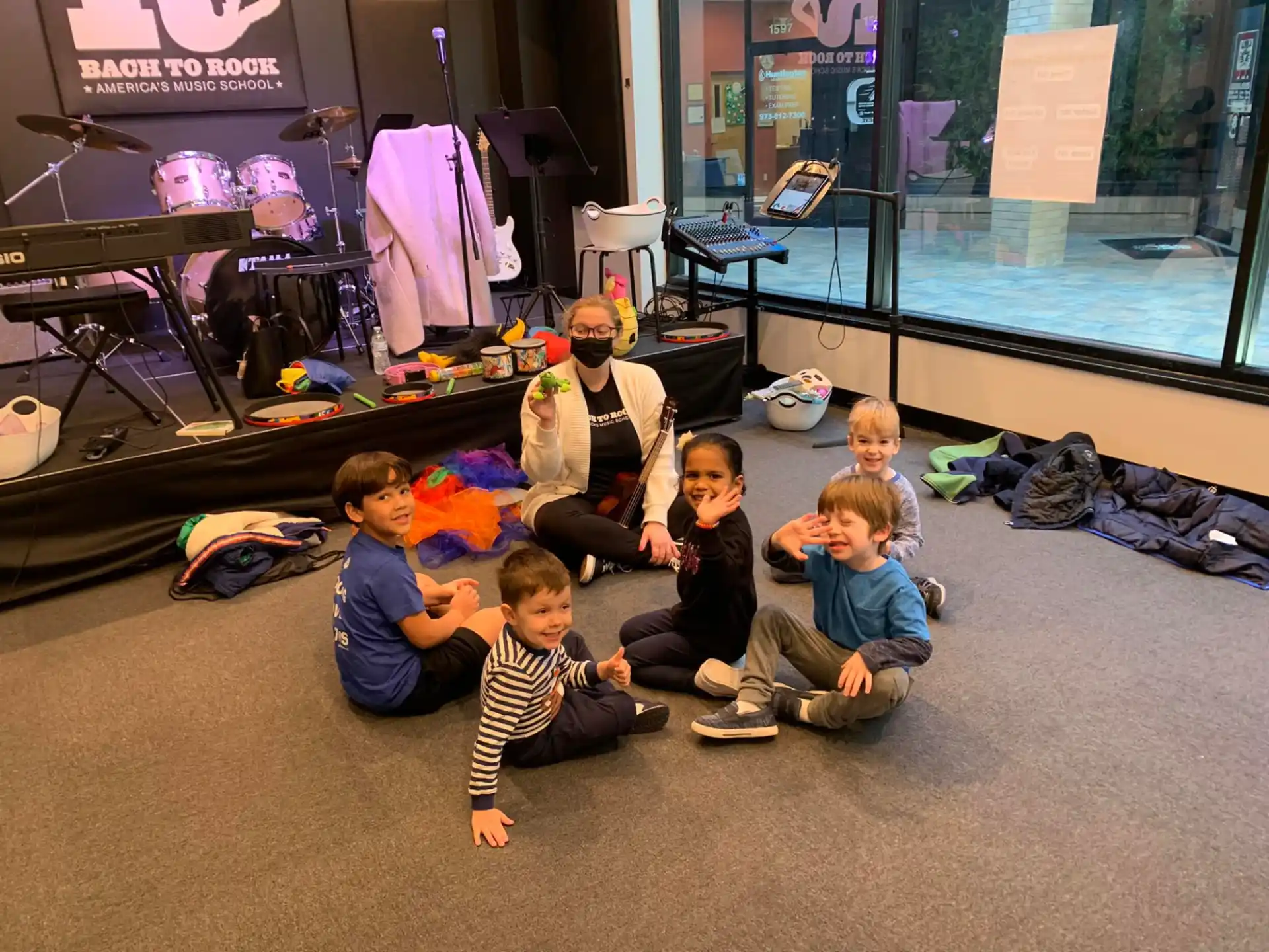 a group of kids sitting on the floor