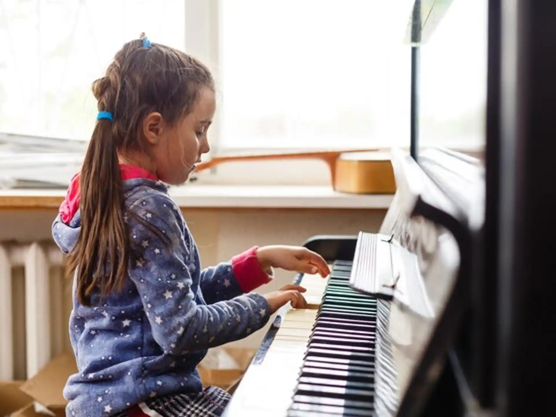 a girl playing a piano