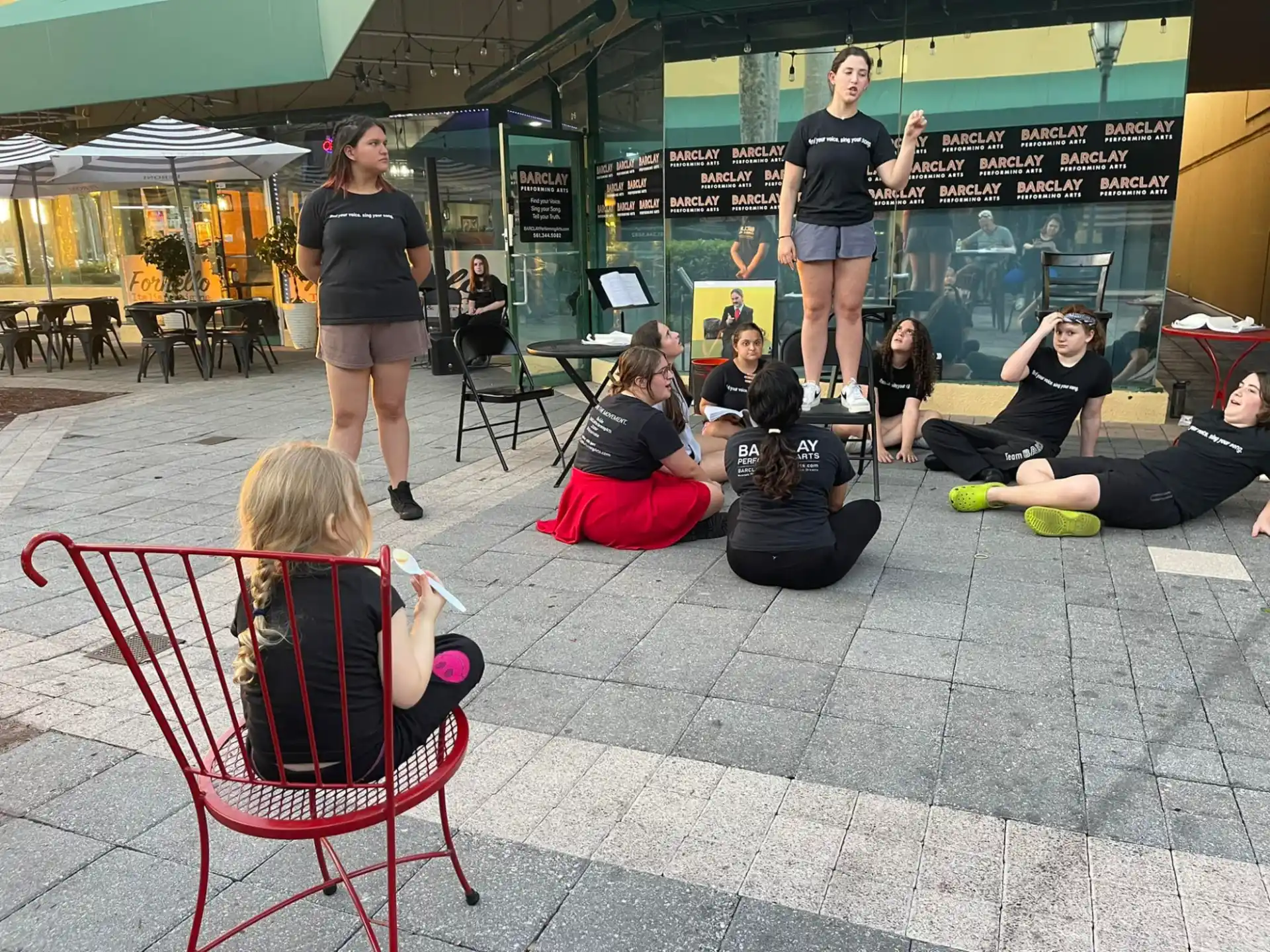 a group of people sitting on the ground outside