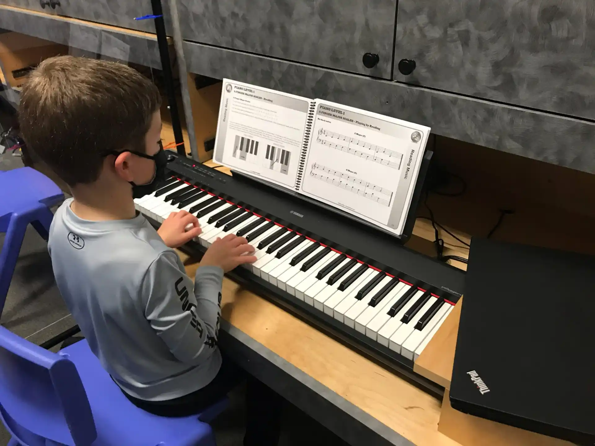 a boy playing a piano