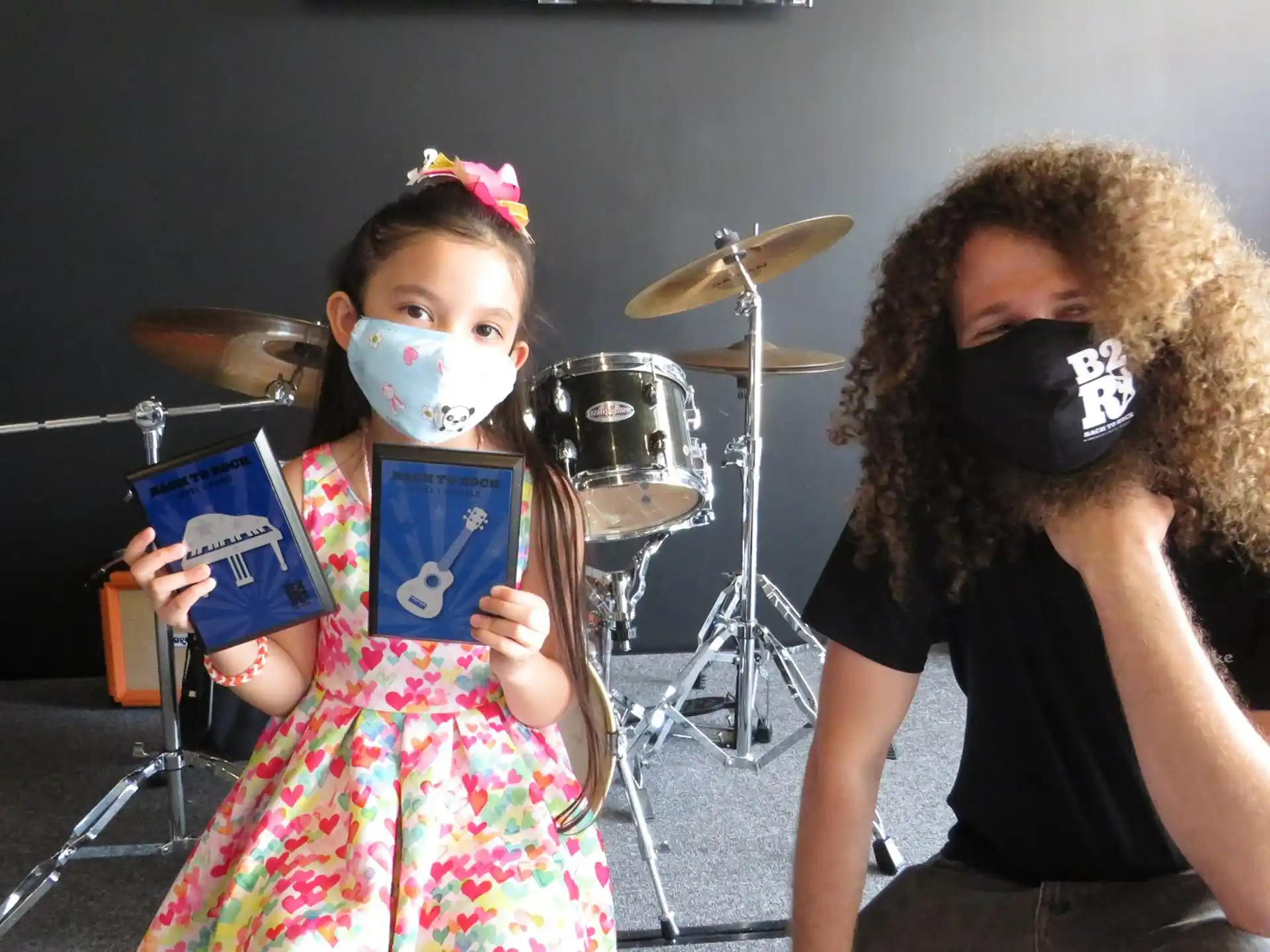 a girl wearing a mask and a girl wearing a mask