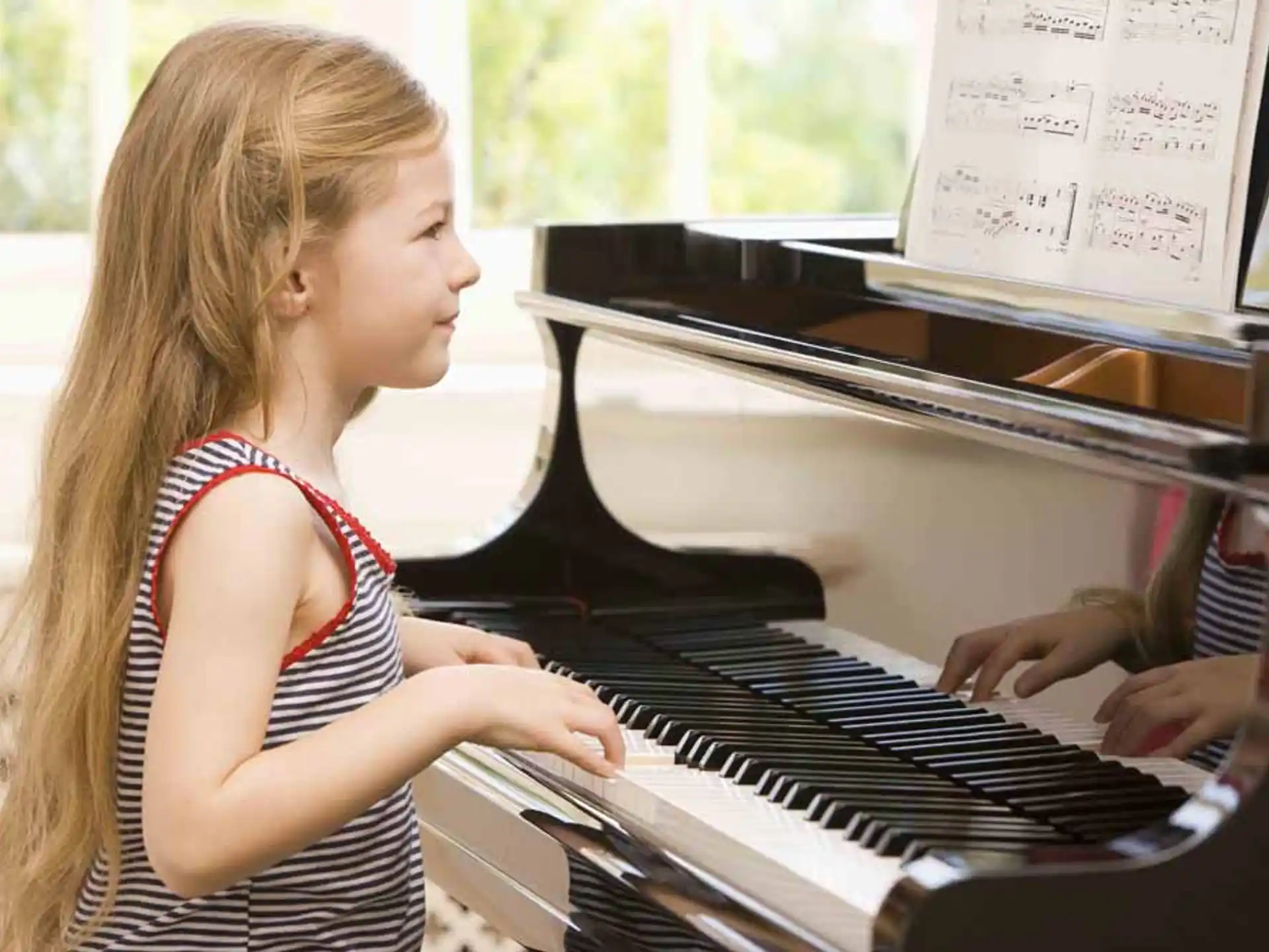 a woman playing a piano