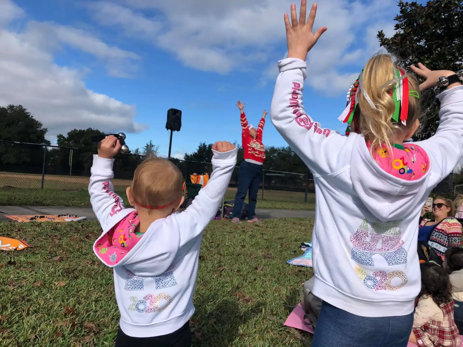a group of children raising their hands