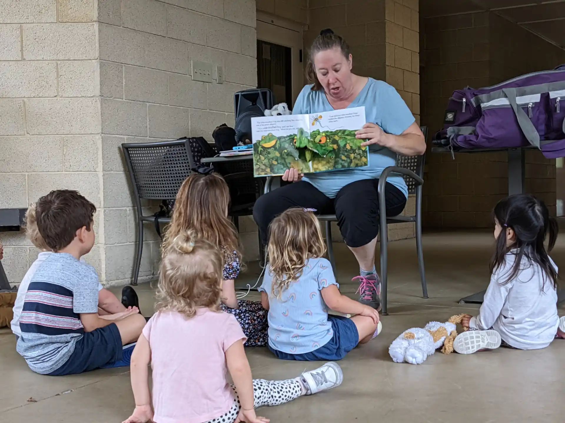 a man reading a book to children