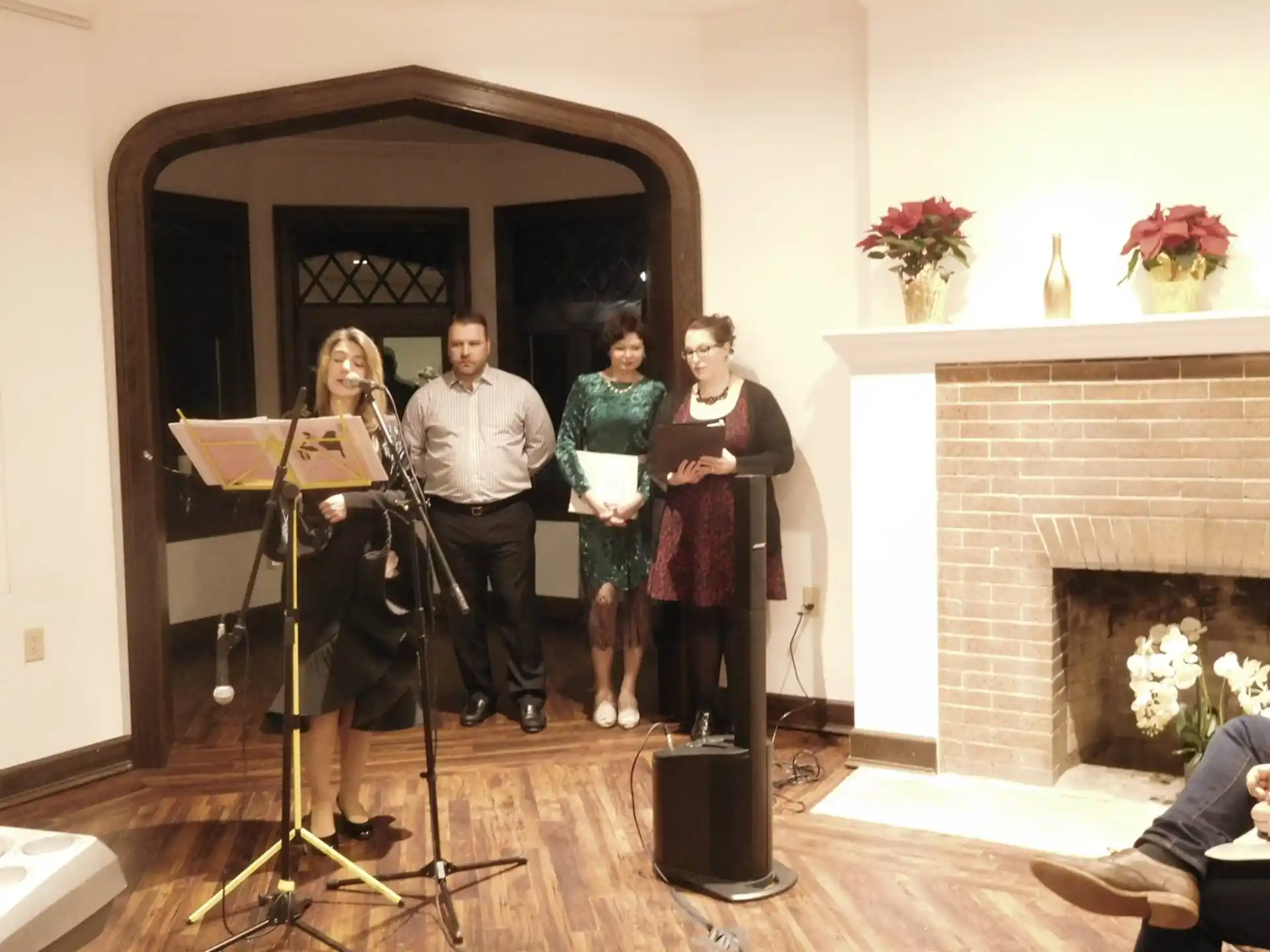 a group of people standing in front of a fireplace