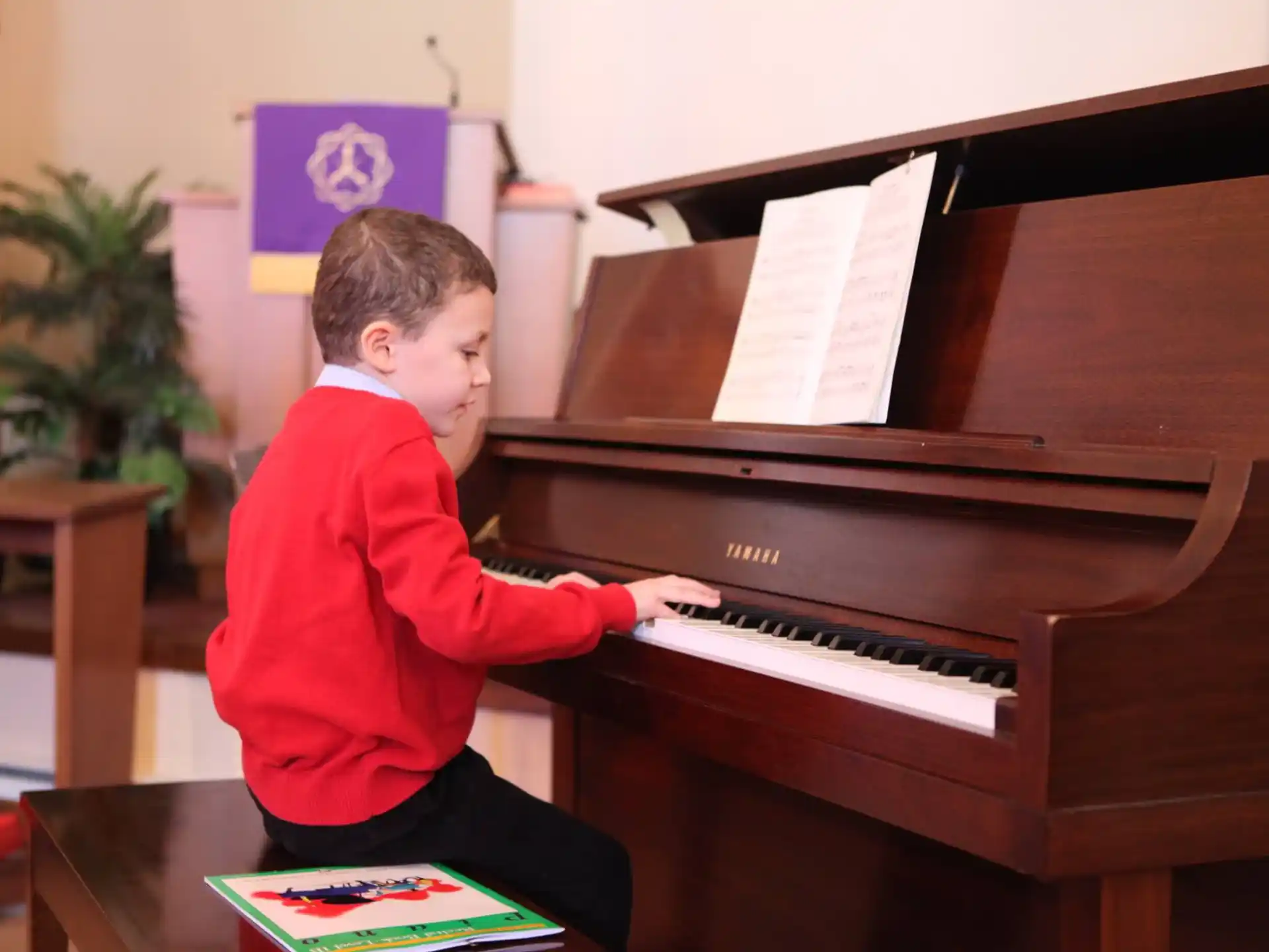 a boy playing a piano