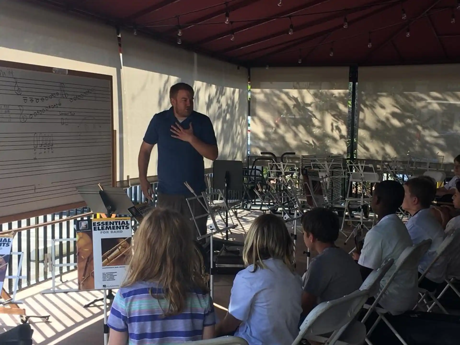 a person standing in front of a group of people sitting in chairs