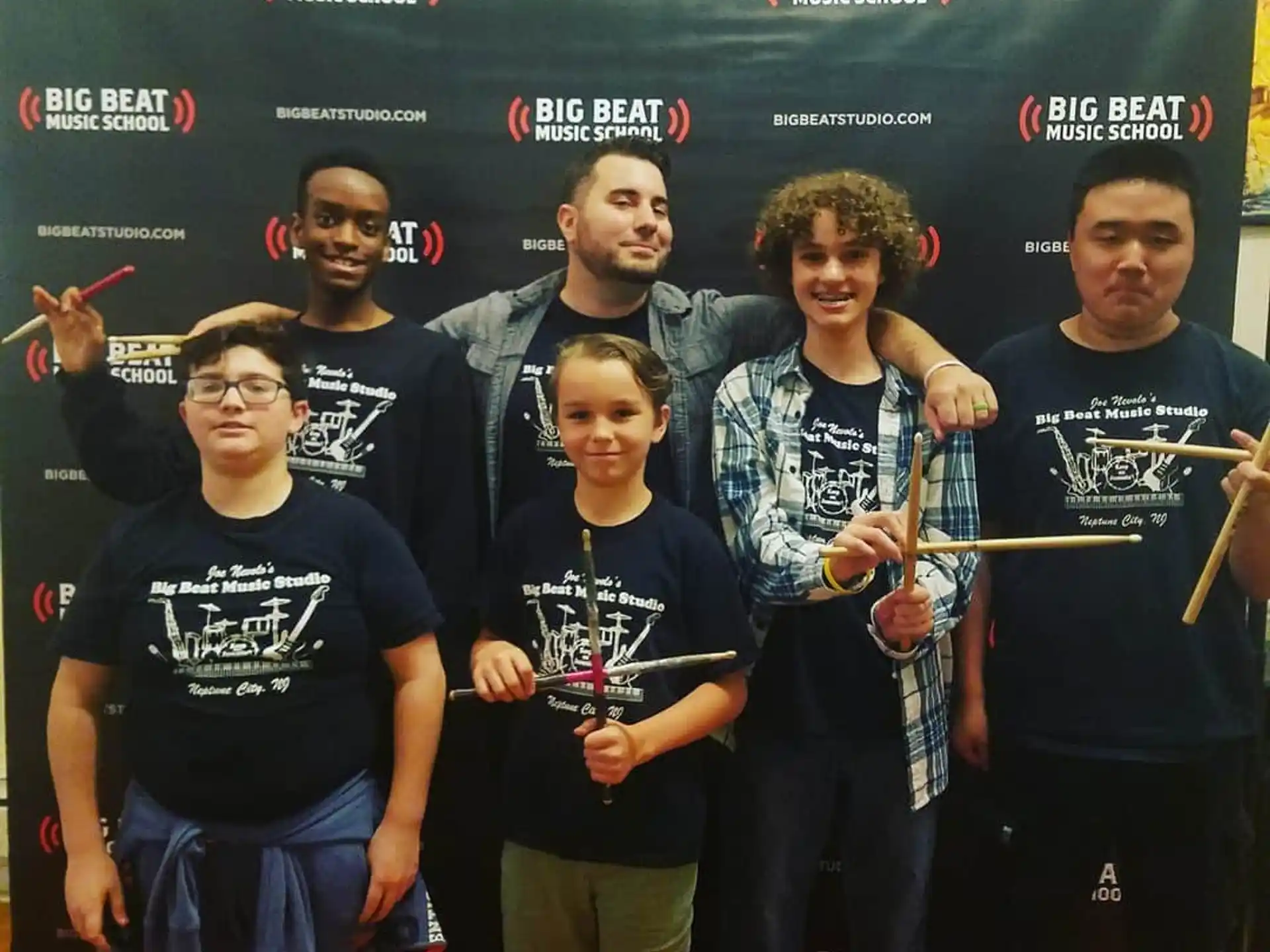 a group of men holding trophies