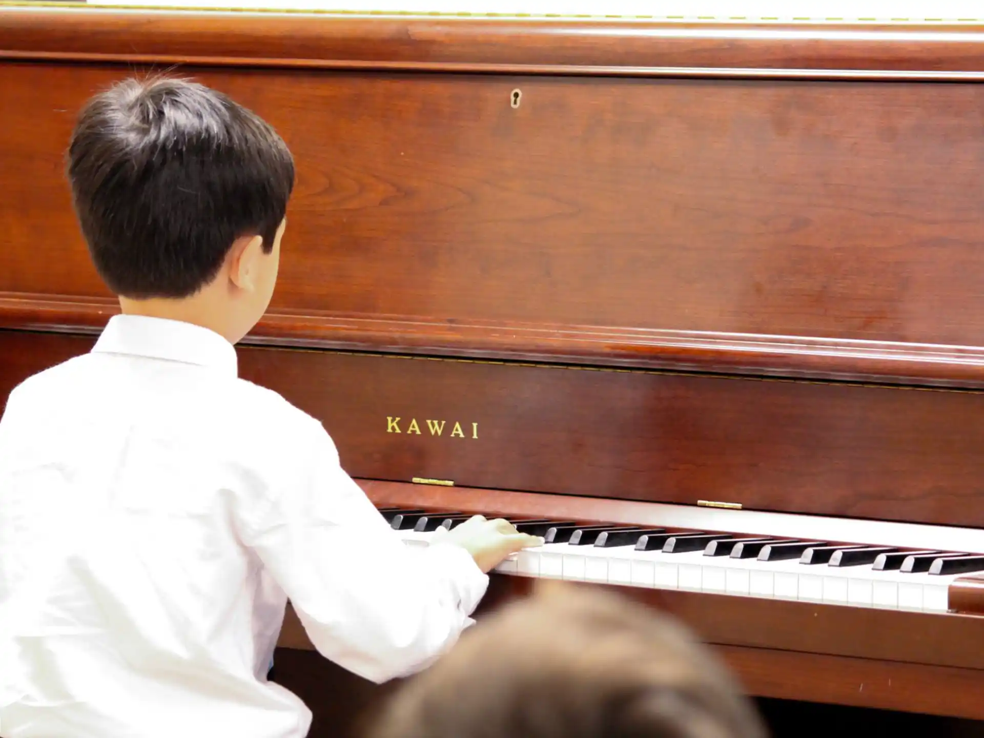a boy playing a piano
