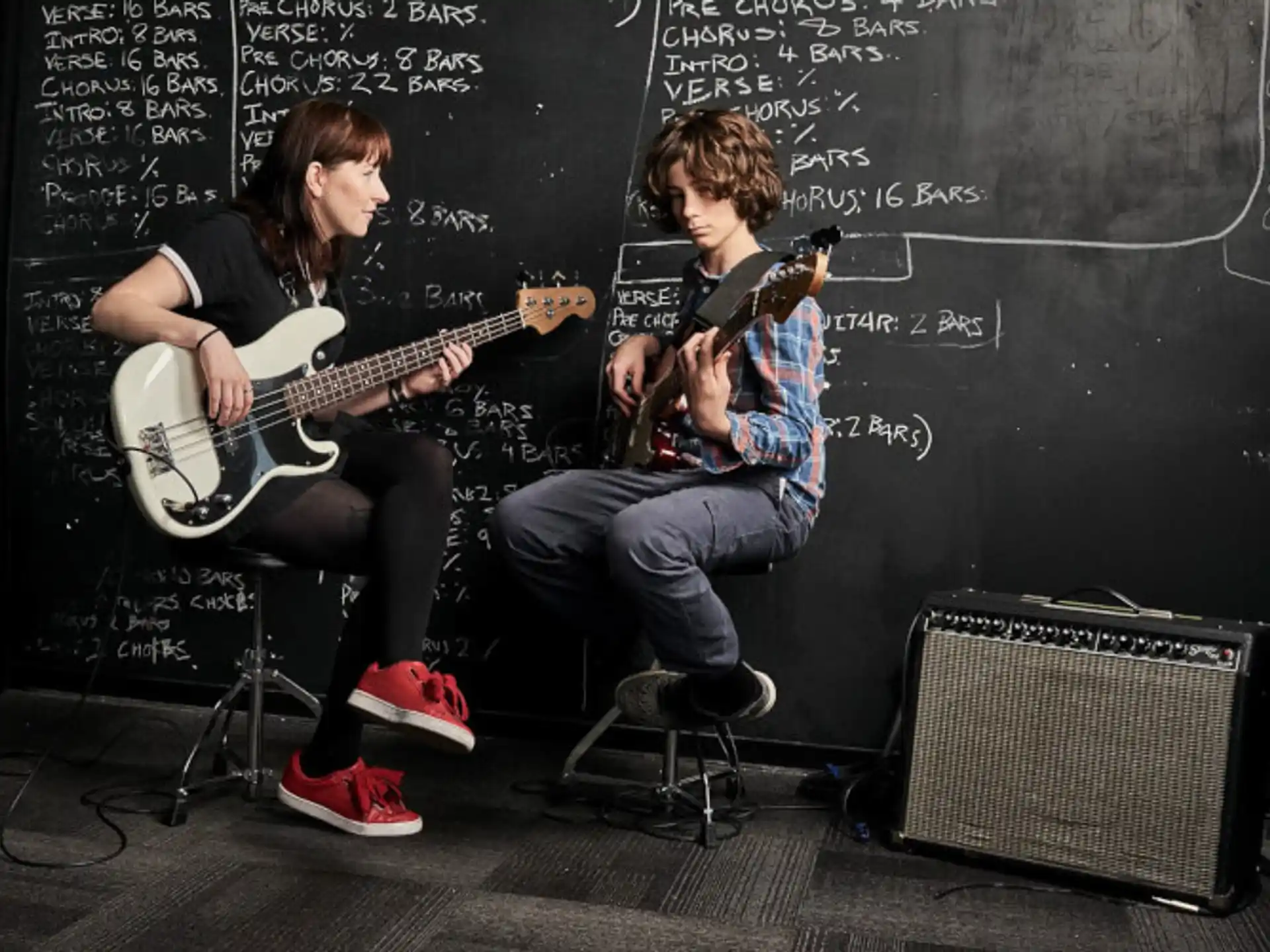a couple of people playing guitars