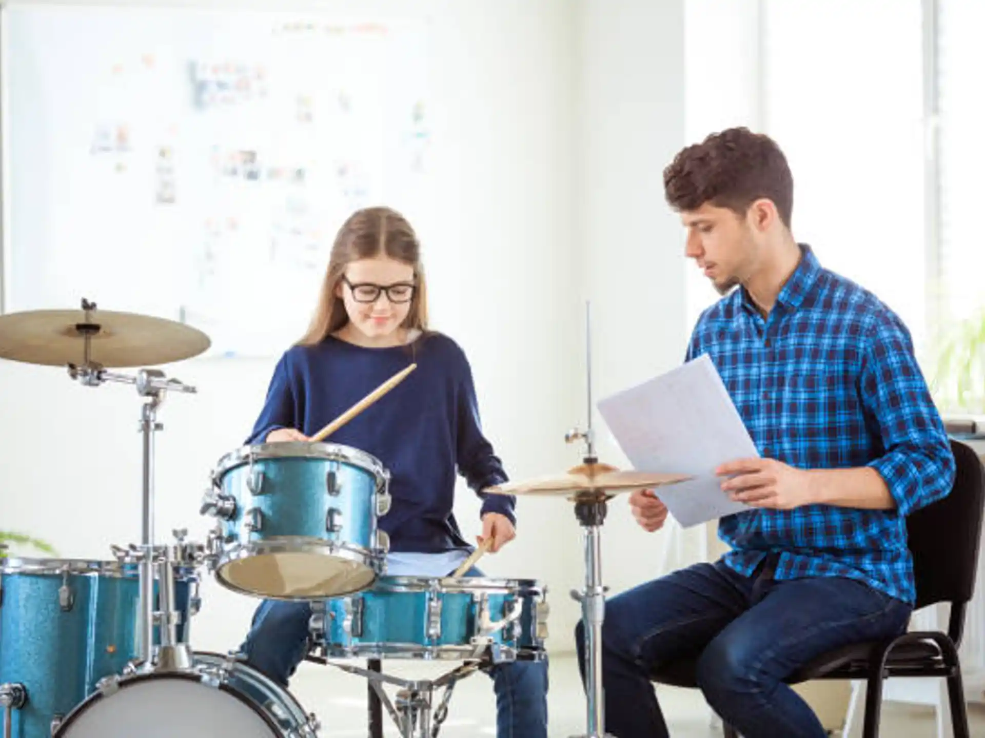 a man and a woman playing drums