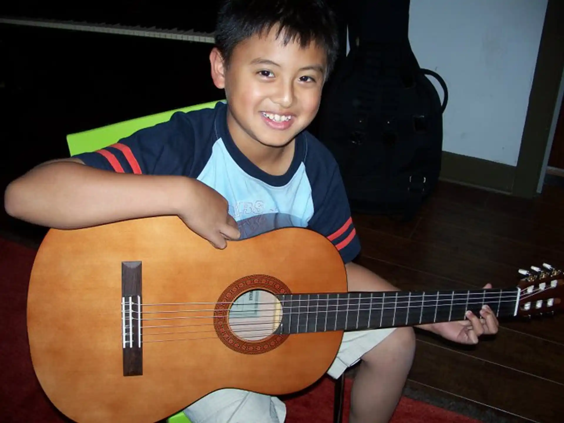 a boy holding a guitar