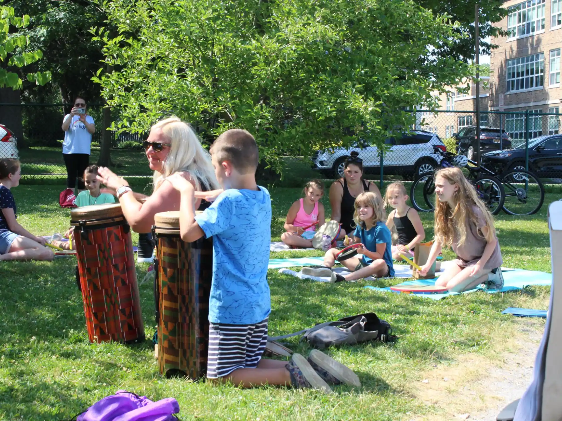 a group of people sitting on the grass