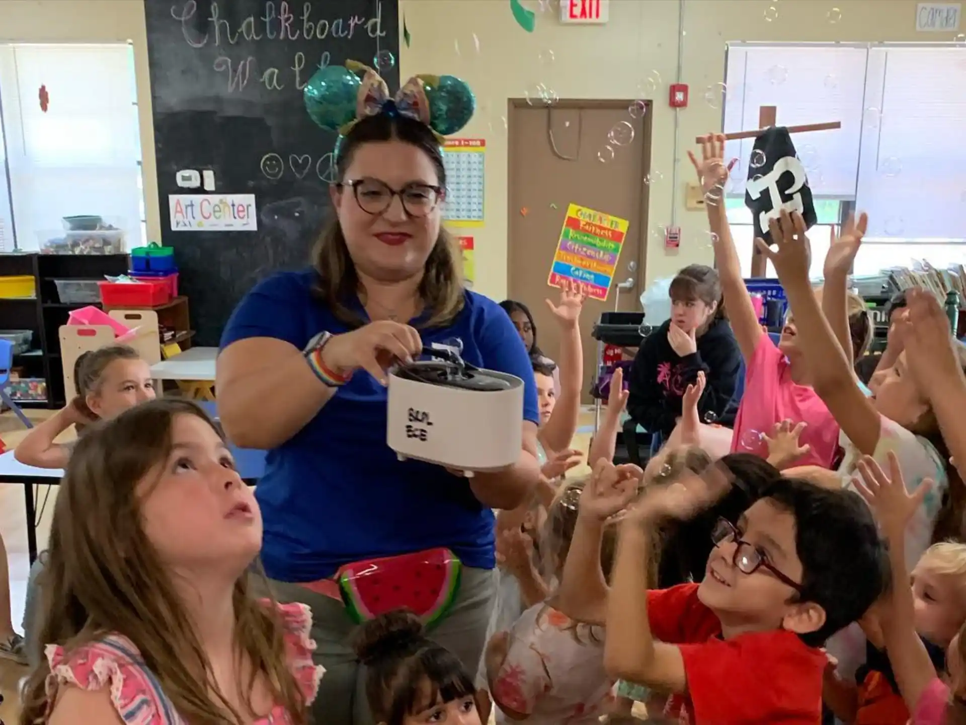 a person standing in front of a group of children
