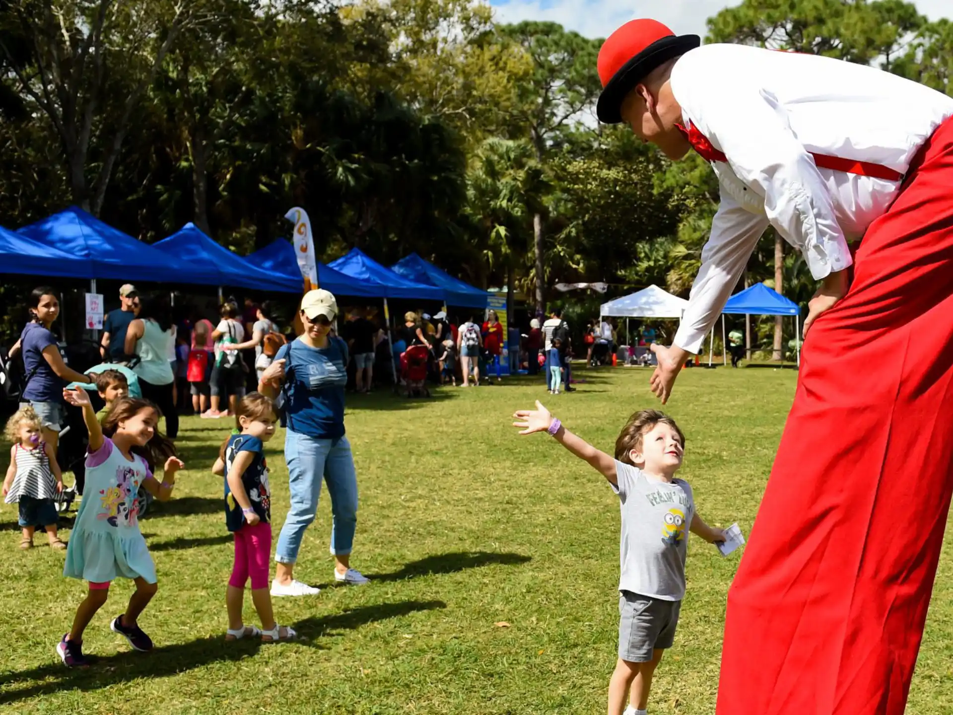 a man in a garment with a child in front of a crowd